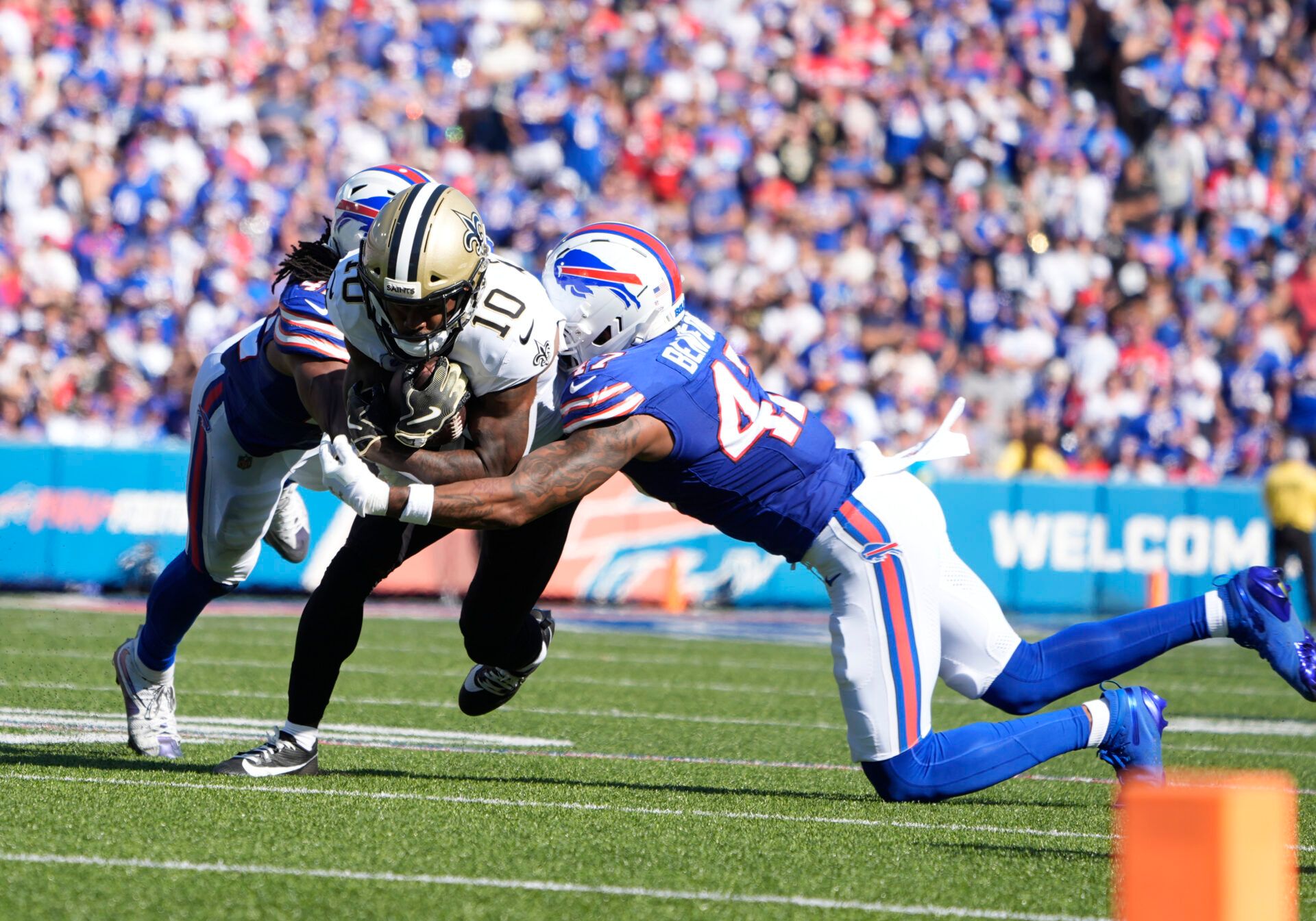 New Orleans Saints wide receiver Brandin Cooks (10) is tackled by Buffalo Bills cornerback Christian Benford (47) and linebacker Dorian Williams (42) during the fourth quarter at Highmark Stadium.