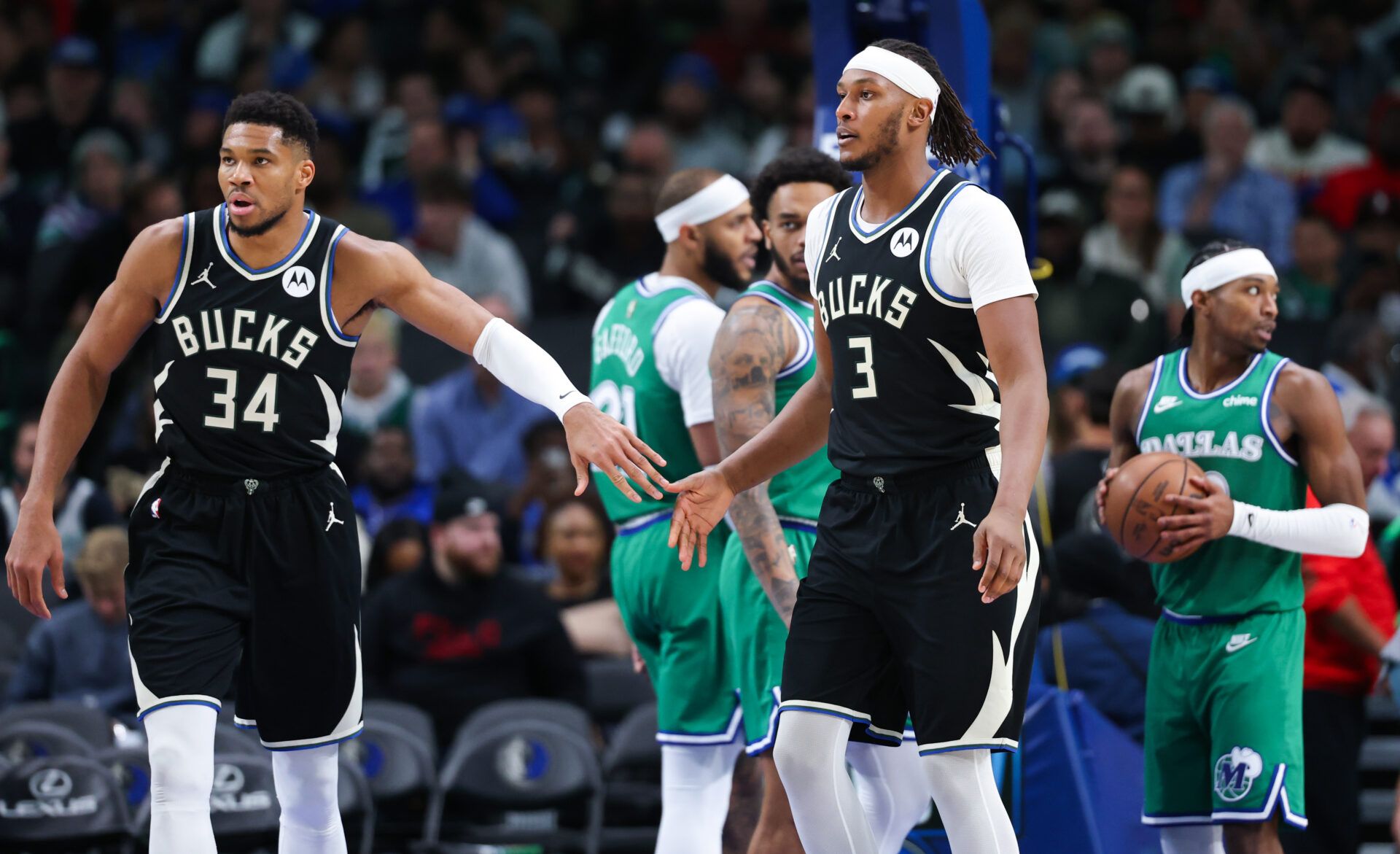 Milwaukee Bucks forward Giannis Antetokounmpo (34) celebrates with Milwaukee Bucks center Myles Turner (3) during the third quarter against the Dallas Mavericks  at American Airlines Center.