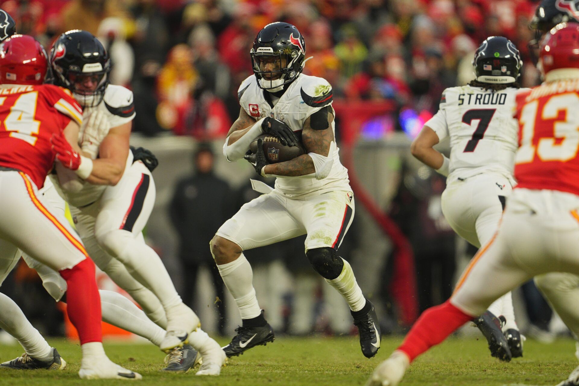 Houston Texans running back Joe Mixon (28) runs the ball against the Kansas City Chiefs during the third quarter of a 2025 AFC divisional round game at GEHA Field at Arrowhead Stadium.