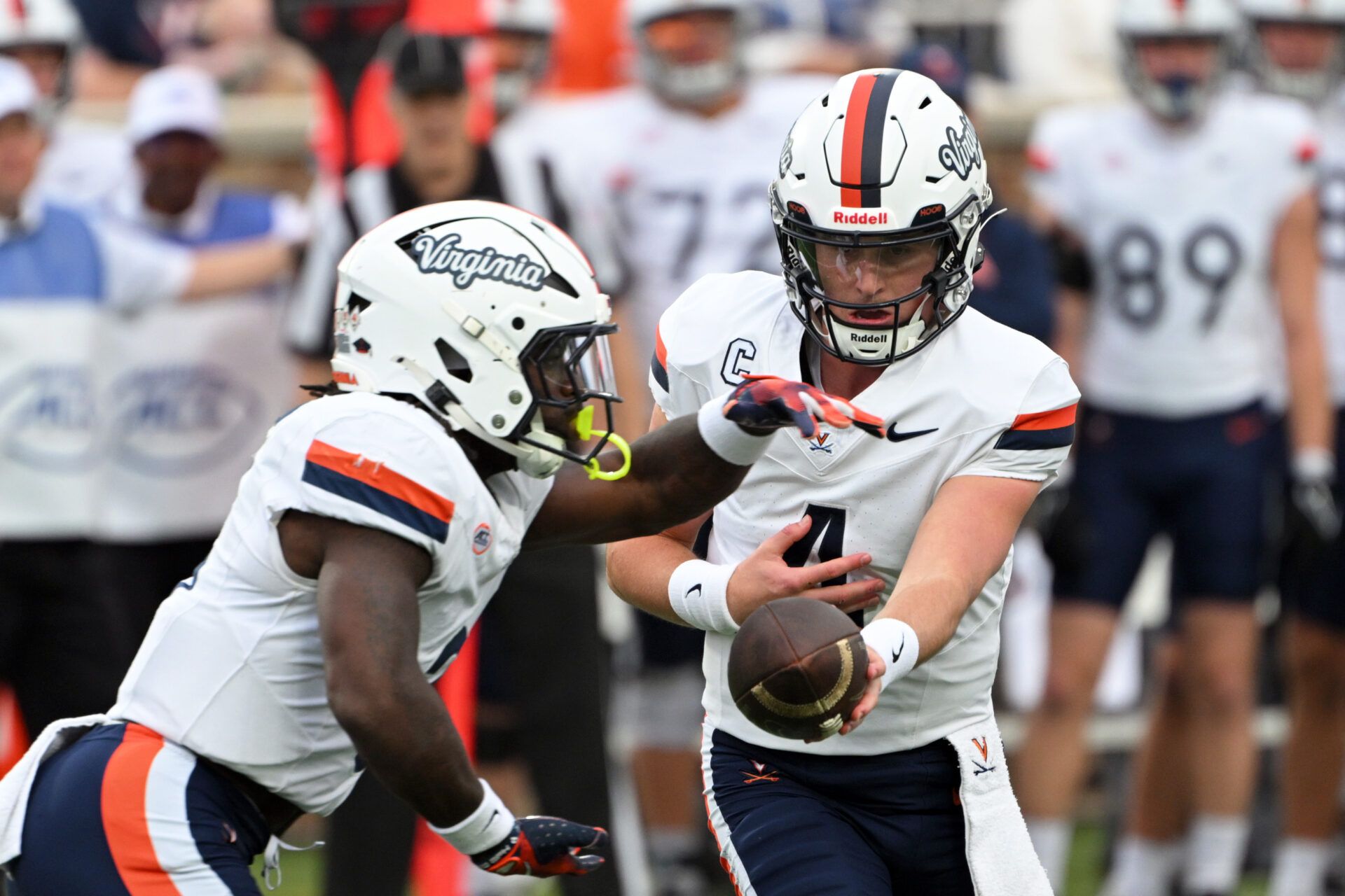 Virginia Cavaliers quarter back Chandler Morris (4) hands the ball to Virginia Cavaliers running back J'Mari Taylor (3) during the first quarter against the Duke Blue Devils at Wallace Wade Stadium.