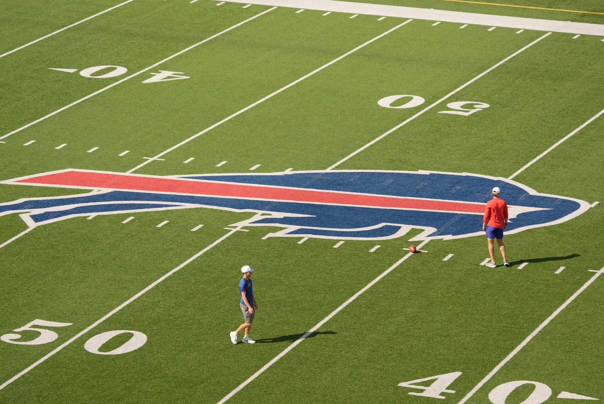 A few personnel come out and set up a ball on the field before the start of the Return of the Blue & Red practice at Highmark Stadium in Orchard Park on 2025.