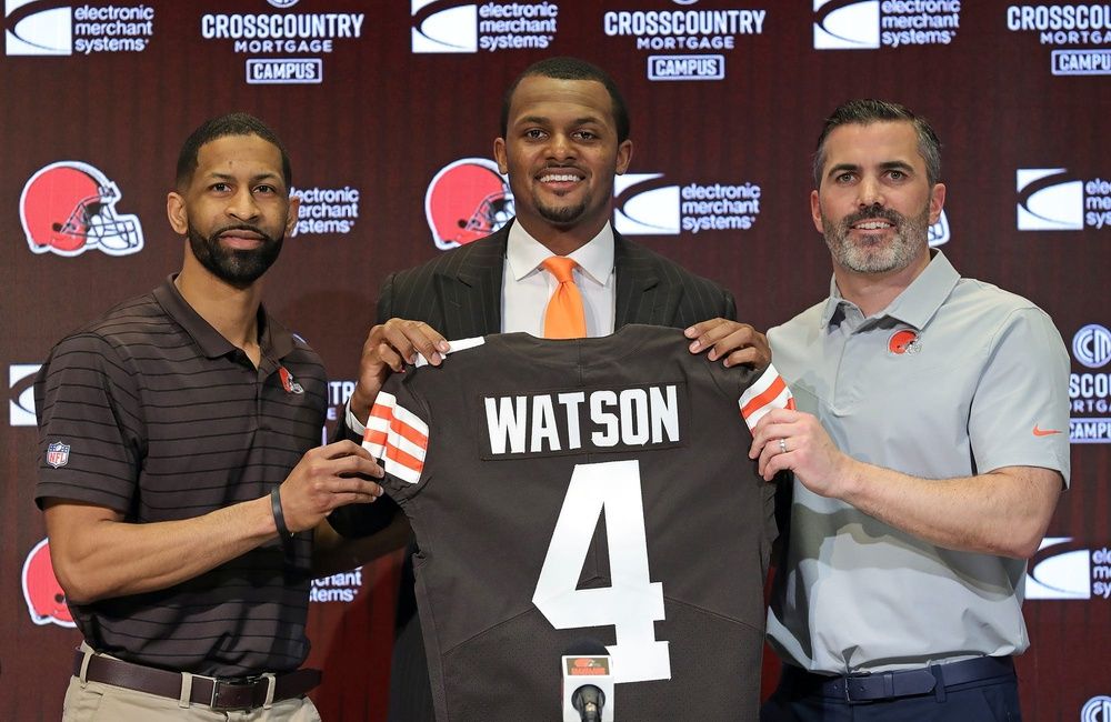 Cleveland Browns quarterback Deshaun Watson, center, poses for a portrait with general manager Andrew Berry, left, and coach Kevin Stefanski during Watson's introductory news conference March 26, 2022, in Berea, Ohio.