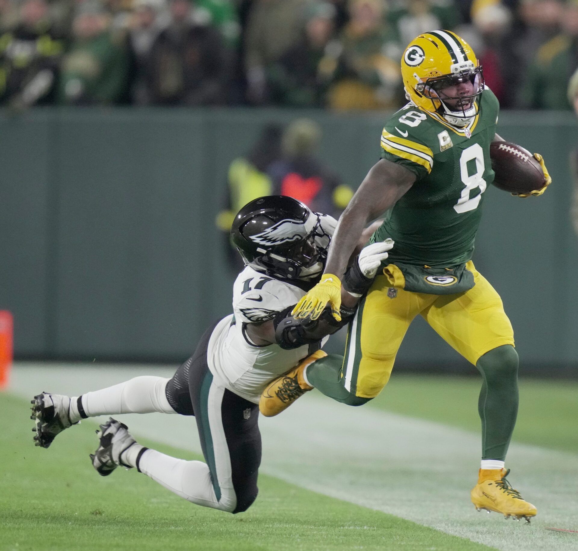 Green Bay Packers running back Josh Jacobs (8) makes a reception for a first down before ebbing tackled by Philadelphia Eagles linebacker Nakobe Dean (17) during the first quarter of their game Monday, November 10, 2025 at Lambeau Field in Green Bay, Wisconsin.