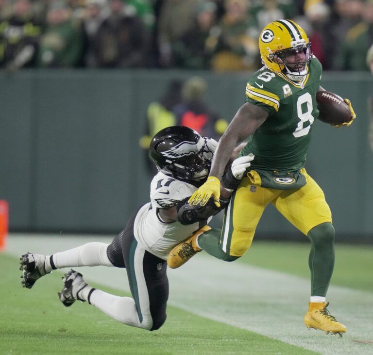 Green Bay Packers running back Josh Jacobs (8) makes a reception for a first down before ebbing tackled by Philadelphia Eagles linebacker Nakobe Dean (17) during the first quarter of their game Monday, November 10, 2025 at Lambeau Field in Green Bay, Wisconsin.