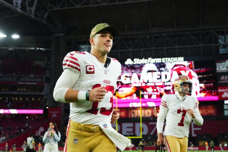 San Francisco 49ers quarterback Brock Purdy (13) runs off the field after defeating the Arizona Cardinals at State Farm Stadium.