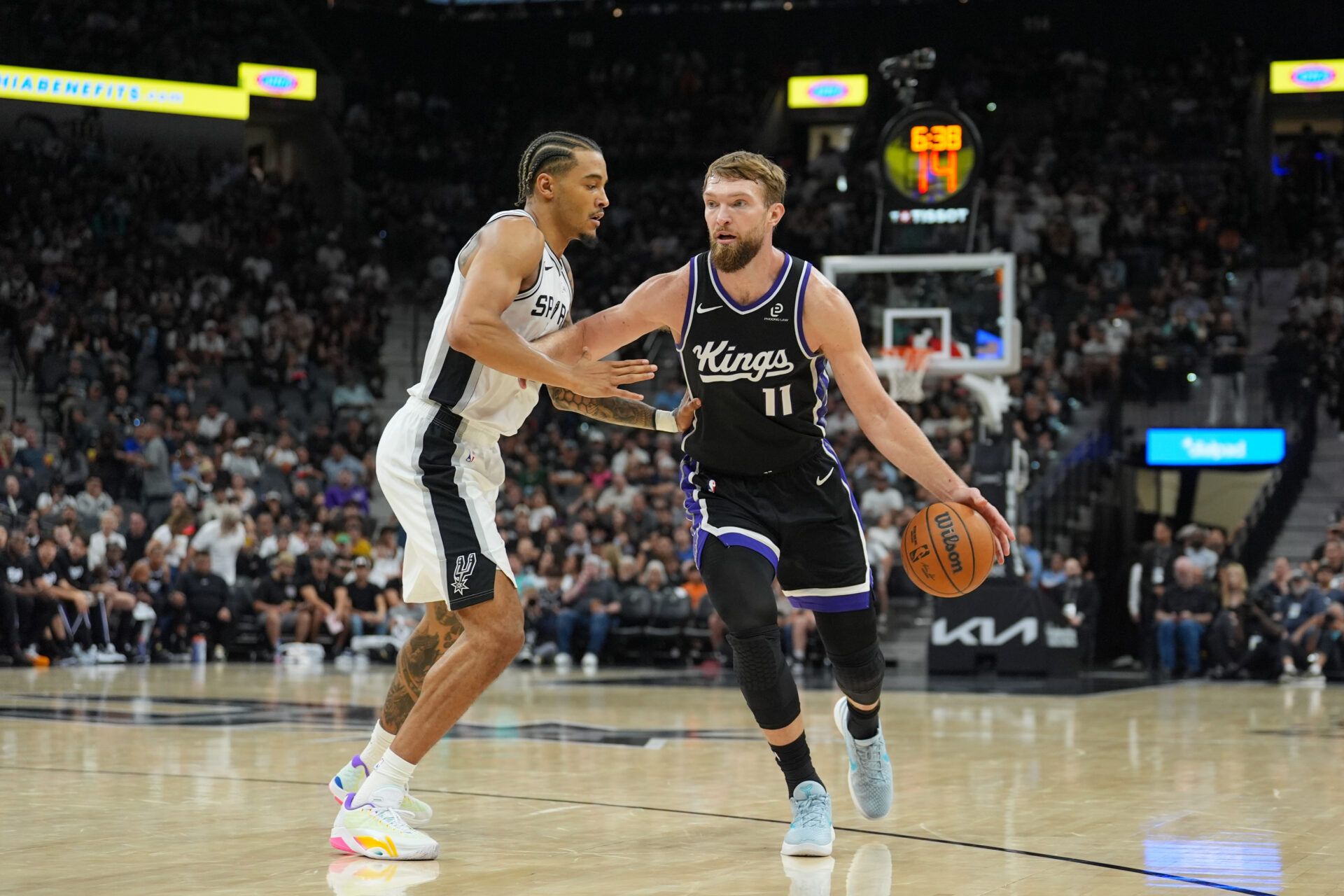Sacramento Kings forward Domantas Sabonis (11) dribbles against San Antonio Spurs forward Jeremy Sochan (10) in the second half at Frost Bank Center.