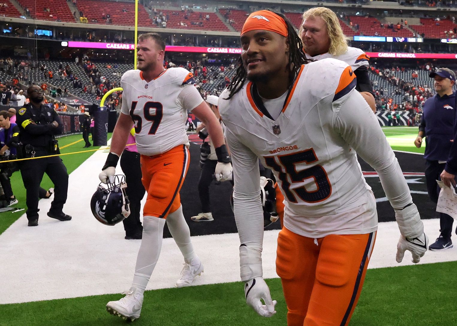 Denver Broncos offensive tackle Mike McGlinchey (69) and linebacker Nik Bonitto (15) celebrate after defeating the Houston Texans at NRG Stadium.