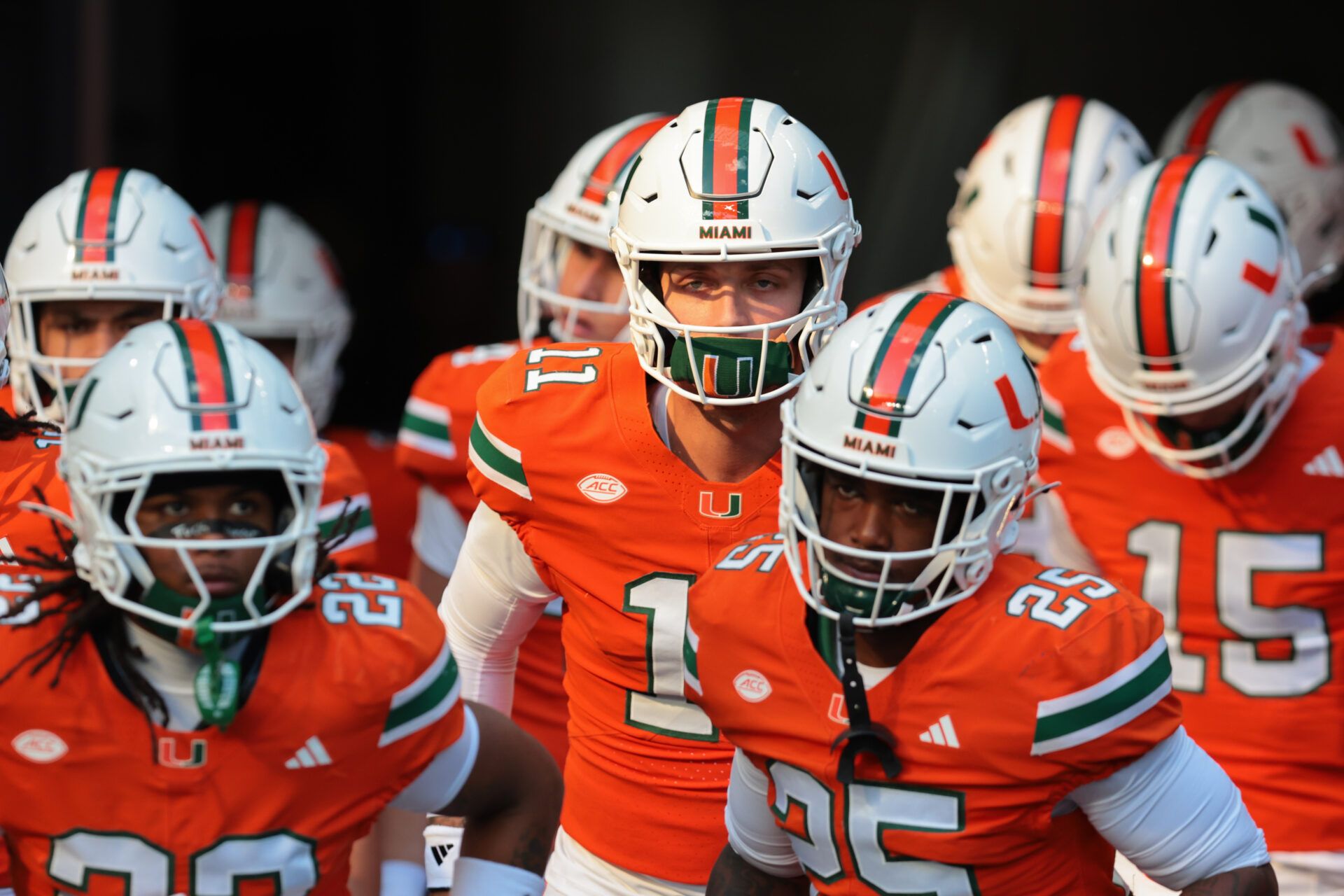 Miami Hurricanes quarterback Carson Beck (center) enters the field to warm up before the game against NC State Wolfpack at Hard Rock Stadium.