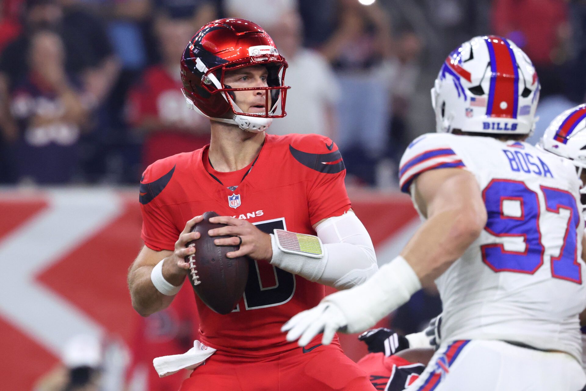 Houston Texans quarterback Davis Mills (10) looks to pass against Buffalo Bills defensive end Joey Bosa (97) in the first quarter at NRG Stadium.