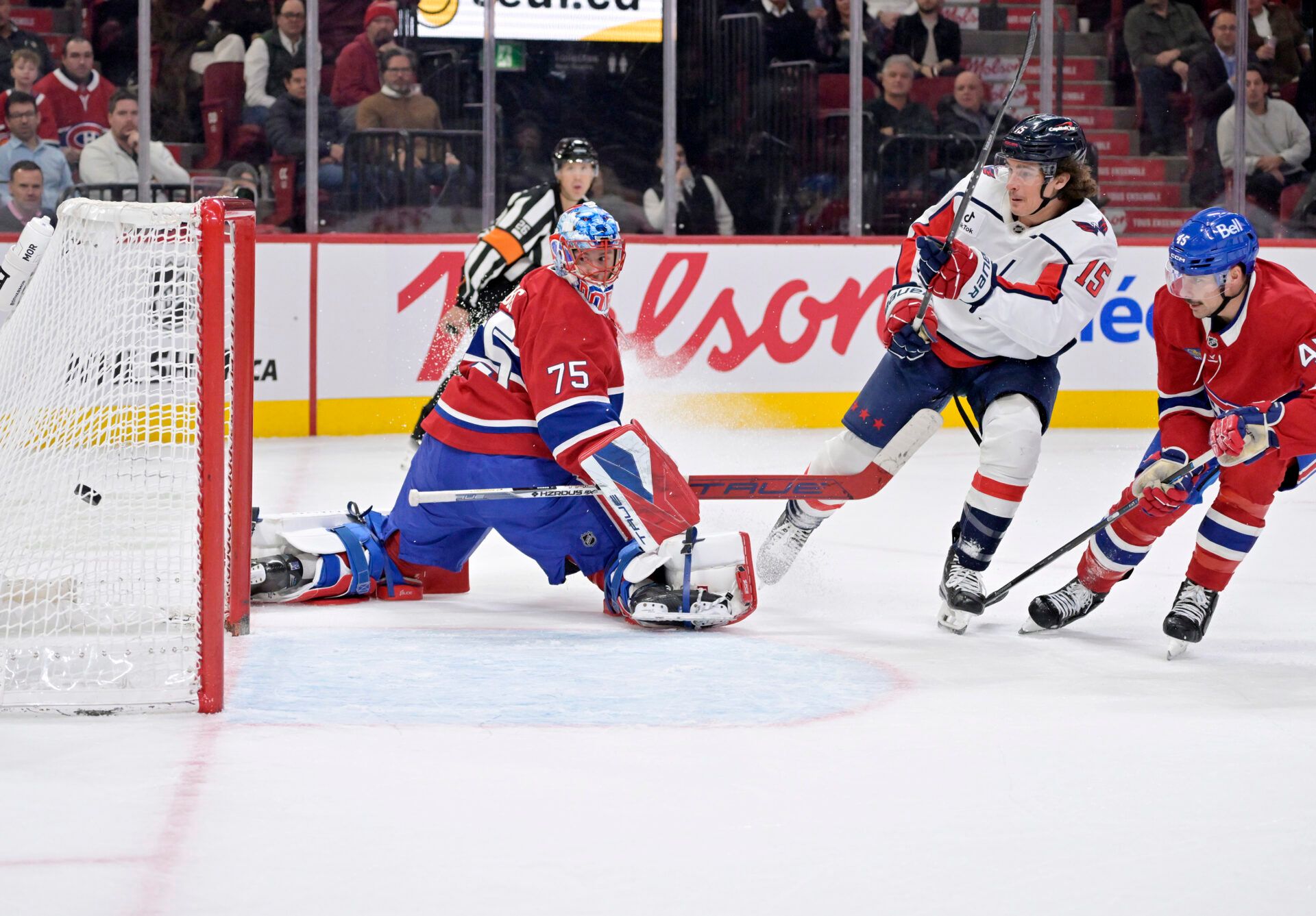 Washington Capitals forward Sonny Milano (15) scores a goal against Montreal Canadiens goalie Jakub Dobes (75) during the second period at the Bell Centre.