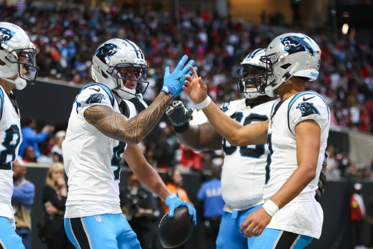 Carolina Panthers quarterback Bryce Young (9) shakes hands with wide receiver Tetairoa McMillan (4) after a touchdown in the fourth quarter against the Atlanta Falcons at Mercedes-Benz Stadium.
