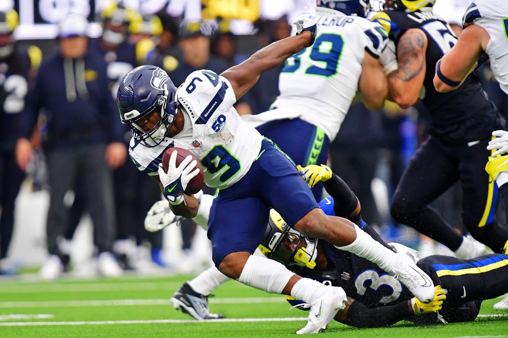 Seattle Seahawks running back Kenneth Walker III (9) runs the ball against Los Angeles Rams safety Kam Curl (3) during the second half at SoFi Stadium.