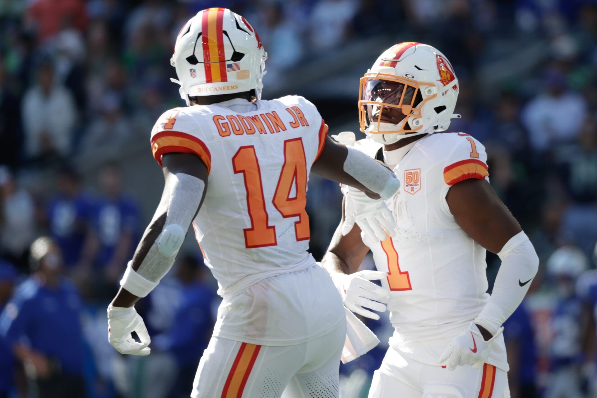 Tampa Bay Buccaneers wide receiver Chris Godwin Jr. (14) and running back Rachaad White (1) react after a first down against the Seattle Seahawks during the first half at Lumen Field.