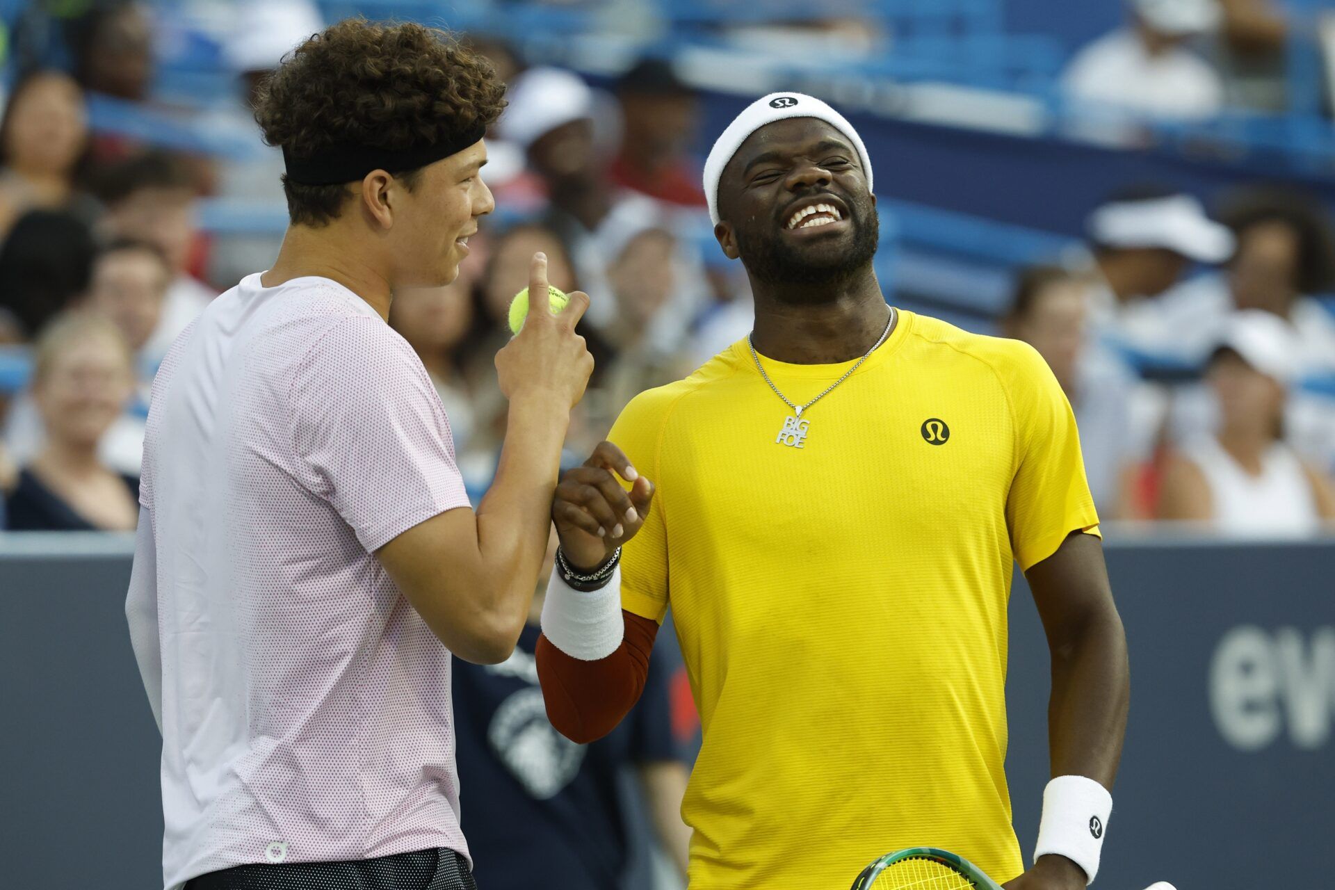 Ben Shelton (USA)(L), jokes with partner Frances Tiafoe (USA)(R) between points against Matthew Ebden and John Peers (both of AUS)(both not pictured) in a men's doubles match on day one of the Mubadala Citi DC Open at Rock Creek Park Tennis Center.