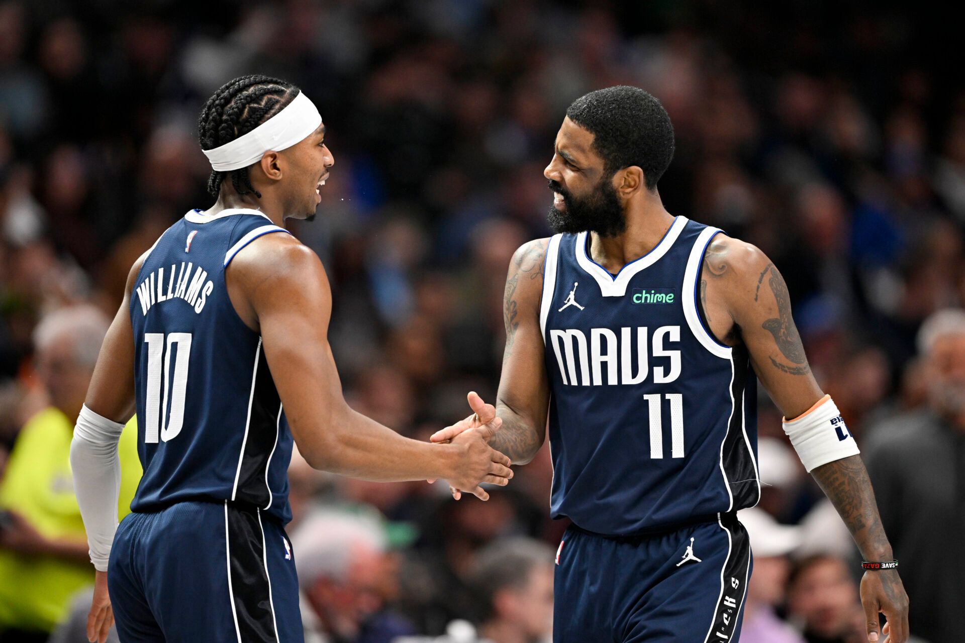 Dallas Mavericks guard Brandon Williams (10) and guard Kyrie Irving (11) celebrate after Irving scores against the Golden State Warriors during the second quarter at the American Airlines Center.