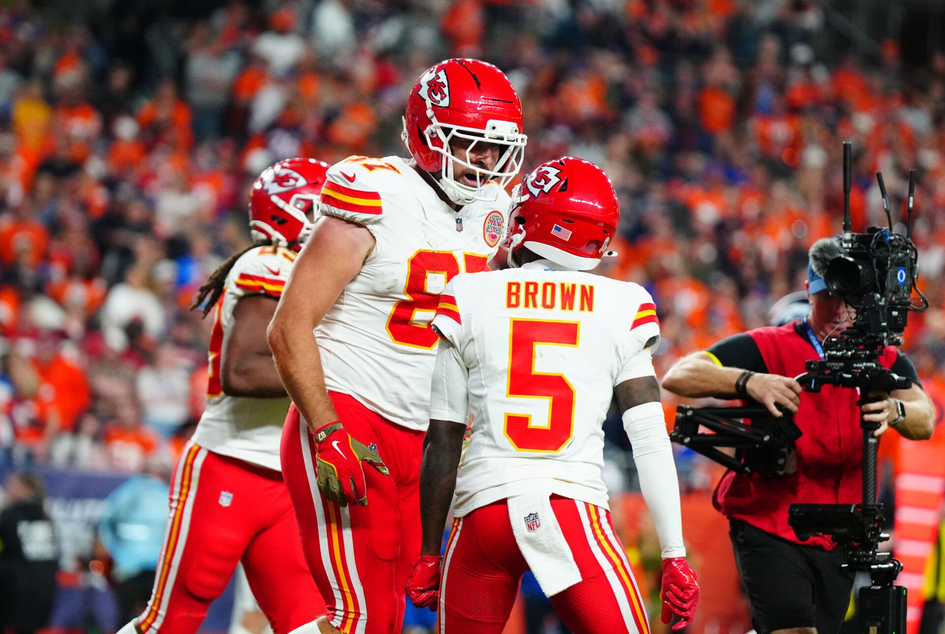 Kansas City Chiefs tight end Travis Kelce (87) celebrates his touchdown with wide receiver Marquise Brown (5) in the fourth quarter against the Denver Broncos at Empower Field at Mile High.