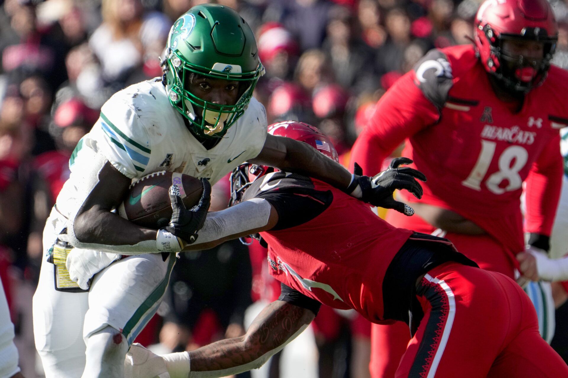 Tulane Green Wave running back Tyjae Spears (22) breaks a tackle by Cincinnati Bearcats safety Ja'von Hicks (3) on a touchdown run in the second quarter during a college football game, Friday, Nov. 25, 2022, at Nippert Stadium in Cincinnati.

Ncaaf Tulane Green Wave At Cincinnati Bearcats Nov 25 0154