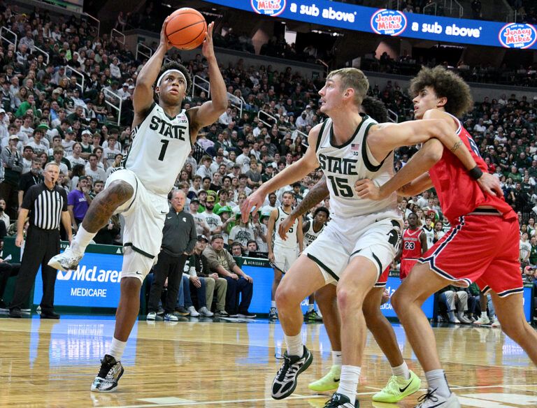 Michigan State Spartans guard Jeremy Fears Jr. (1) drives to the basket during the second half while Michigan State Spartans center Carson Cooper (15) clears a lane for him against the Detroit Mercy Titans at Jack Breslin Student Events Center.