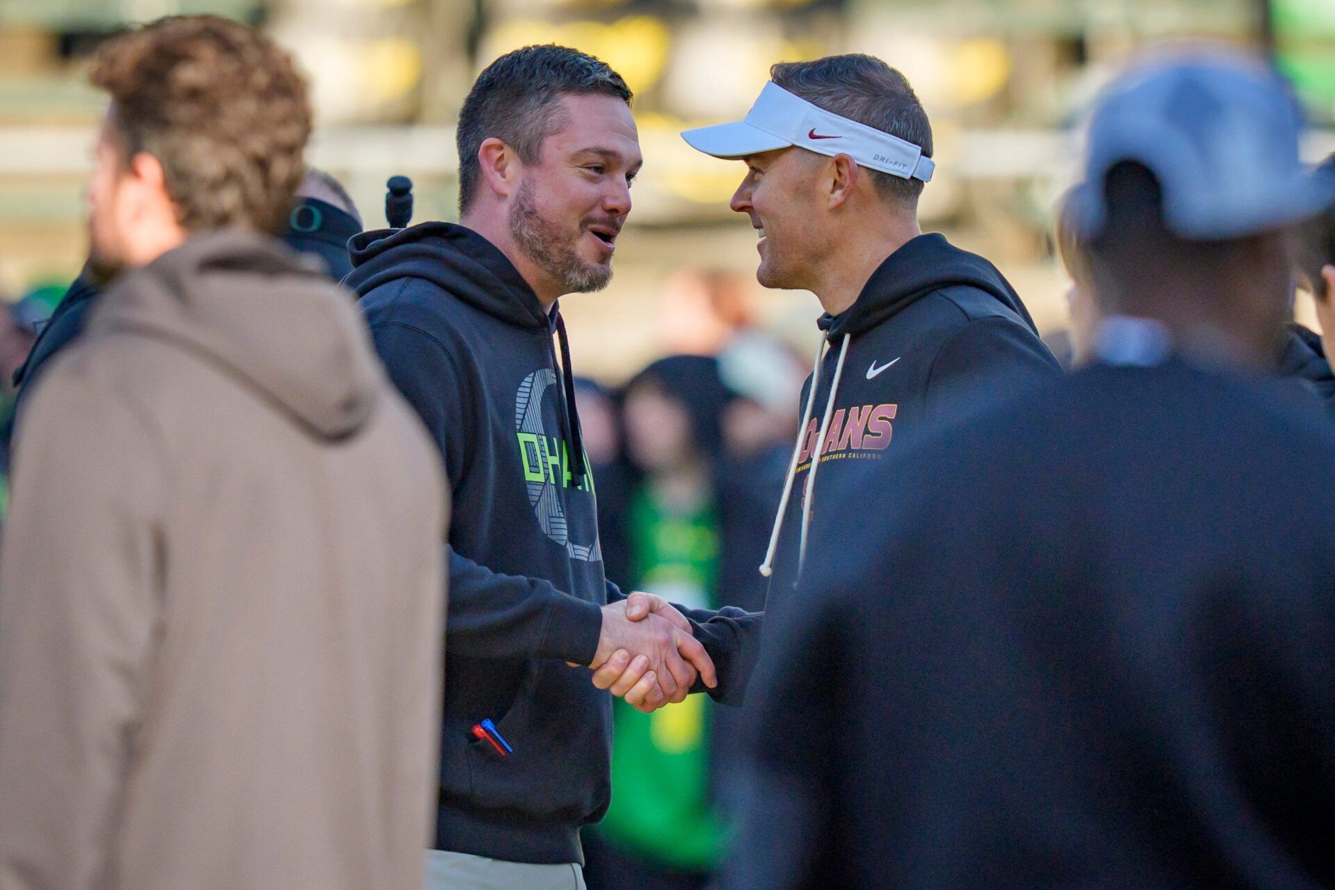 Oregon head coach Dan Lanning, left, and USC head coach Lincoln Riley shake hands before the game as the Oregon Ducks host the USC Trojans on Nov. 22, 2025, at Autzen Stadium in Eugene, Oregon.