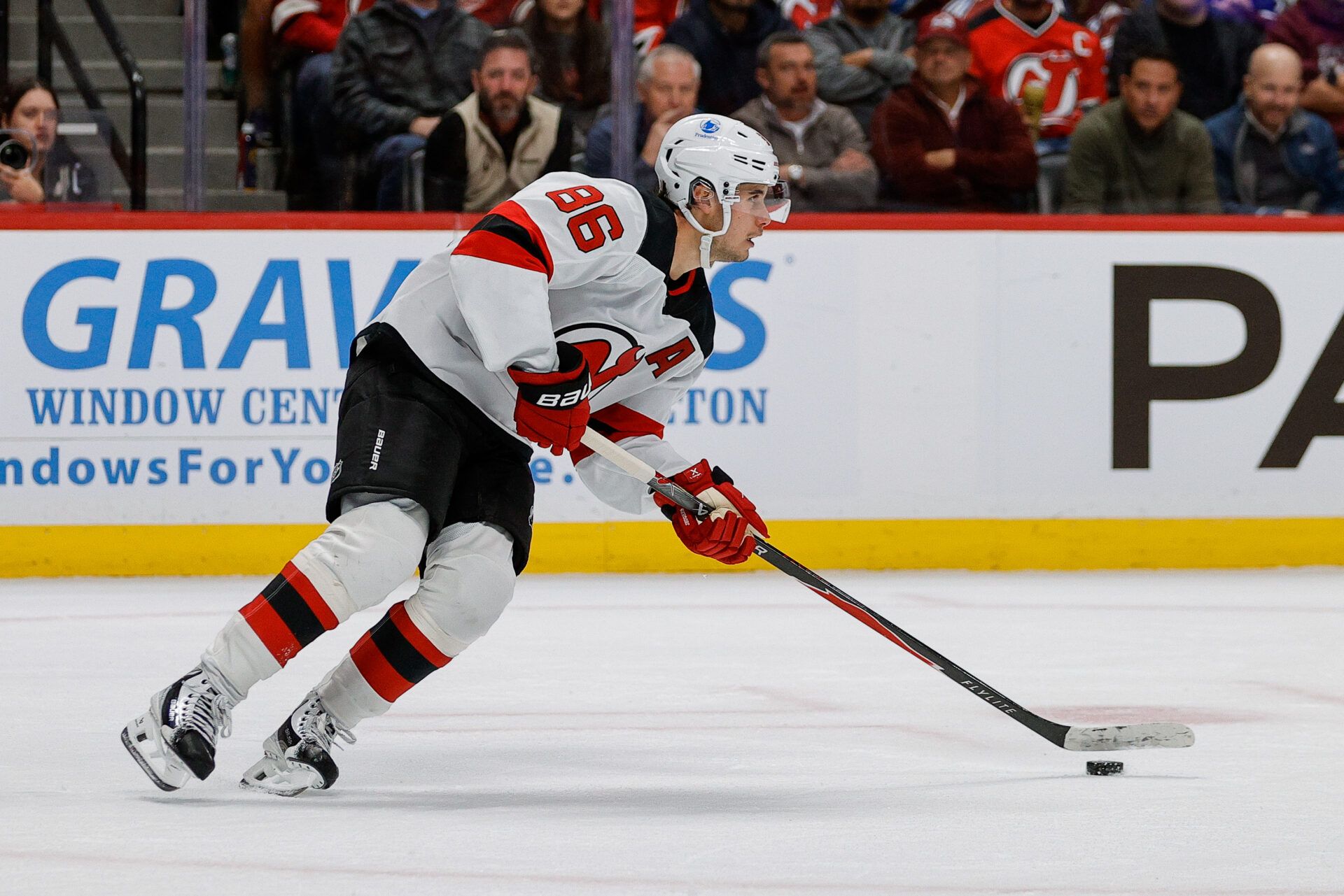 New Jersey Devils center Jack Hughes (86) controls the puck in the second period against the Colorado Avalanche at Ball Arena.