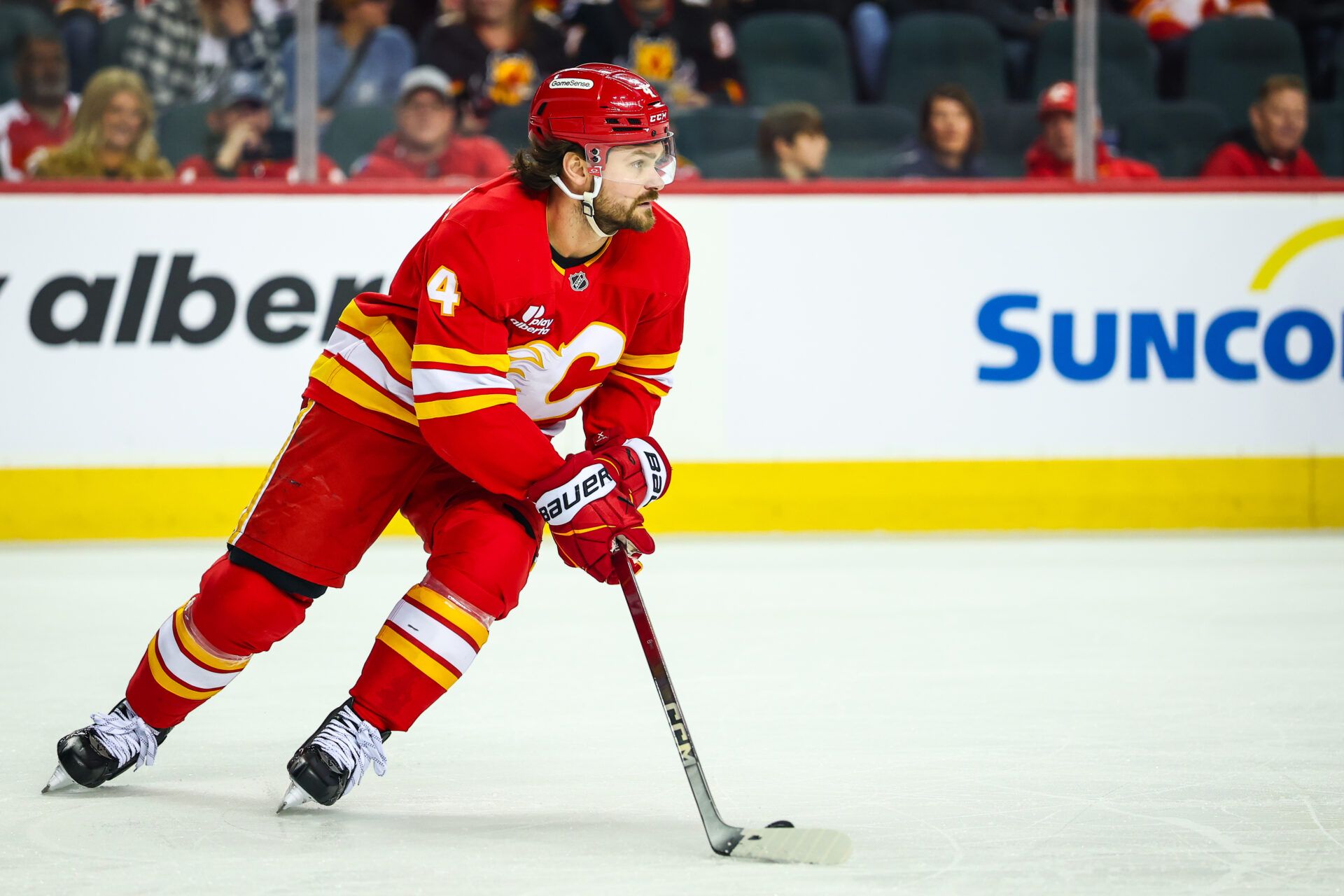 Calgary Flames defenseman Rasmus Andersson (4) skates with the puck against the Winnipeg Jets during the first period at Scotiabank Saddledome.