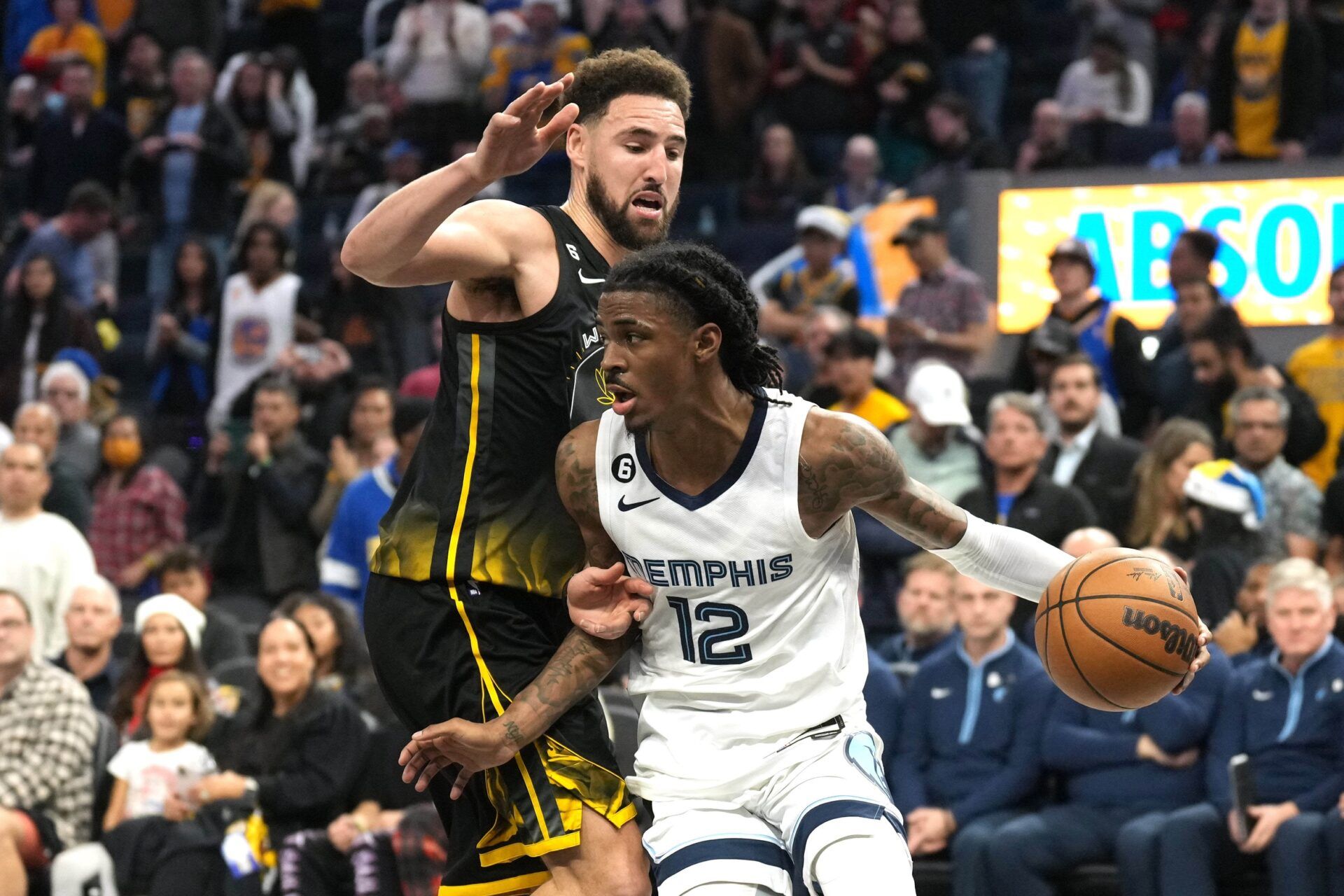 Memphis Grizzlies guard Ja Morant (12) dribbles against Golden State Warriors guard Klay Thompson (11) during the fourth quarter at Chase Center.