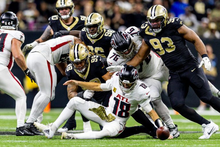 New Orleans Saints defensive end Chase Young (99) forces a fumble by New Orleans Saints quarterback Spencer Rattler (18) as he is sacked during the second half at Caesars Superdome.