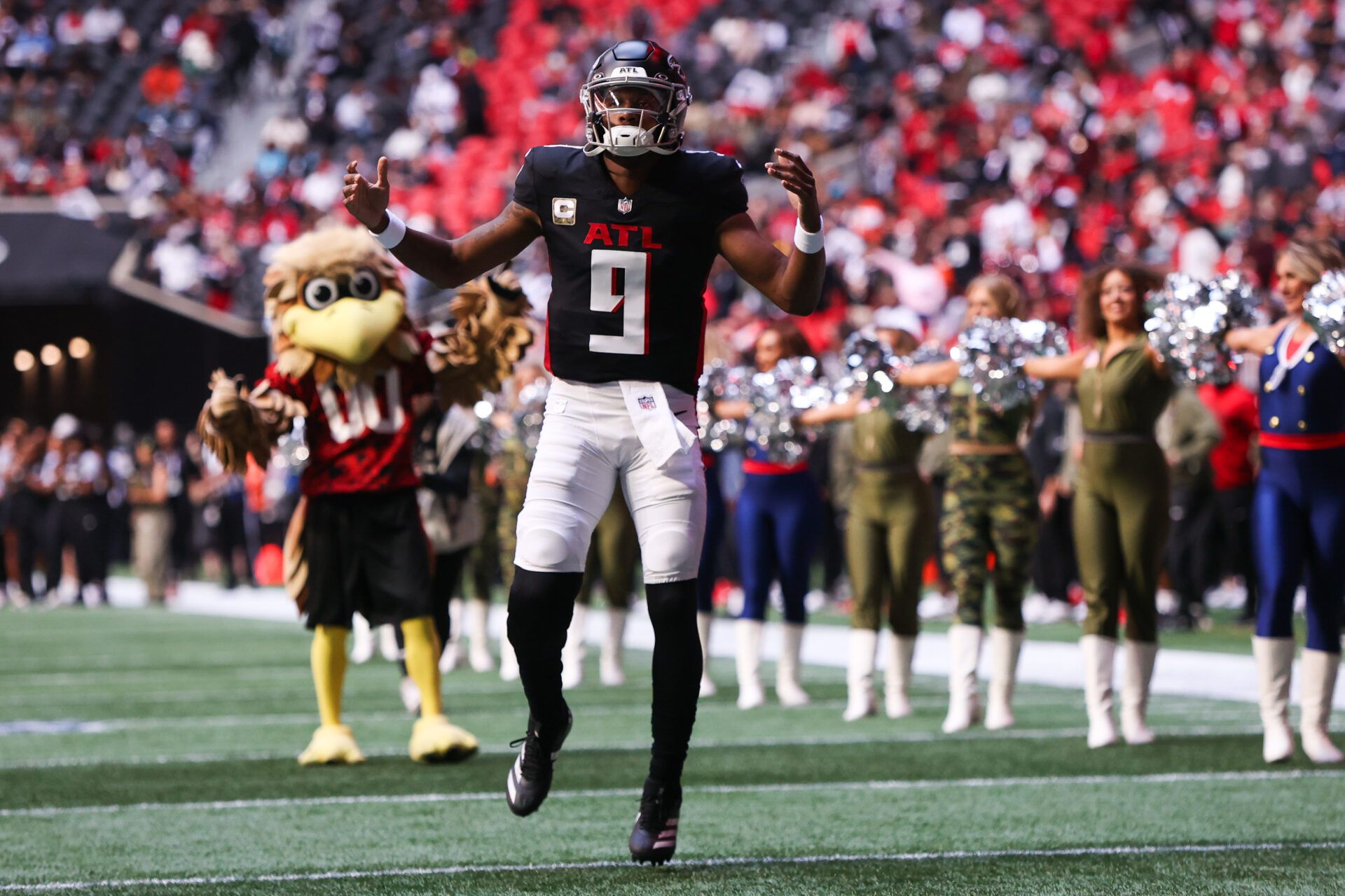 Atlanta Falcons quarterback Michael Penix Jr. (9) enters the field before the game against the Carolina Panthers at Mercedes-Benz Stadium.