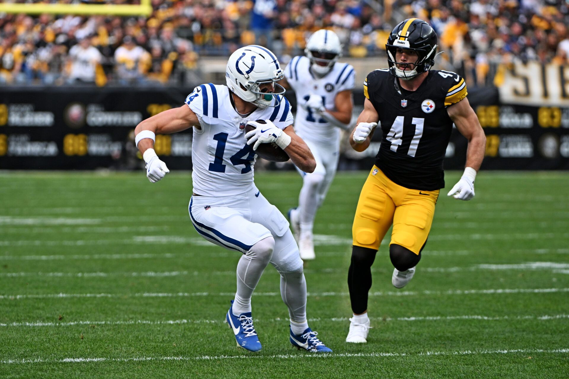 Indianapolis Colts wide receiver Alec Pierce (14) catches a pass during the first half as Pittsburgh Steelers linebacker Payton Wilson (41) defends at Acrisure Stadium.