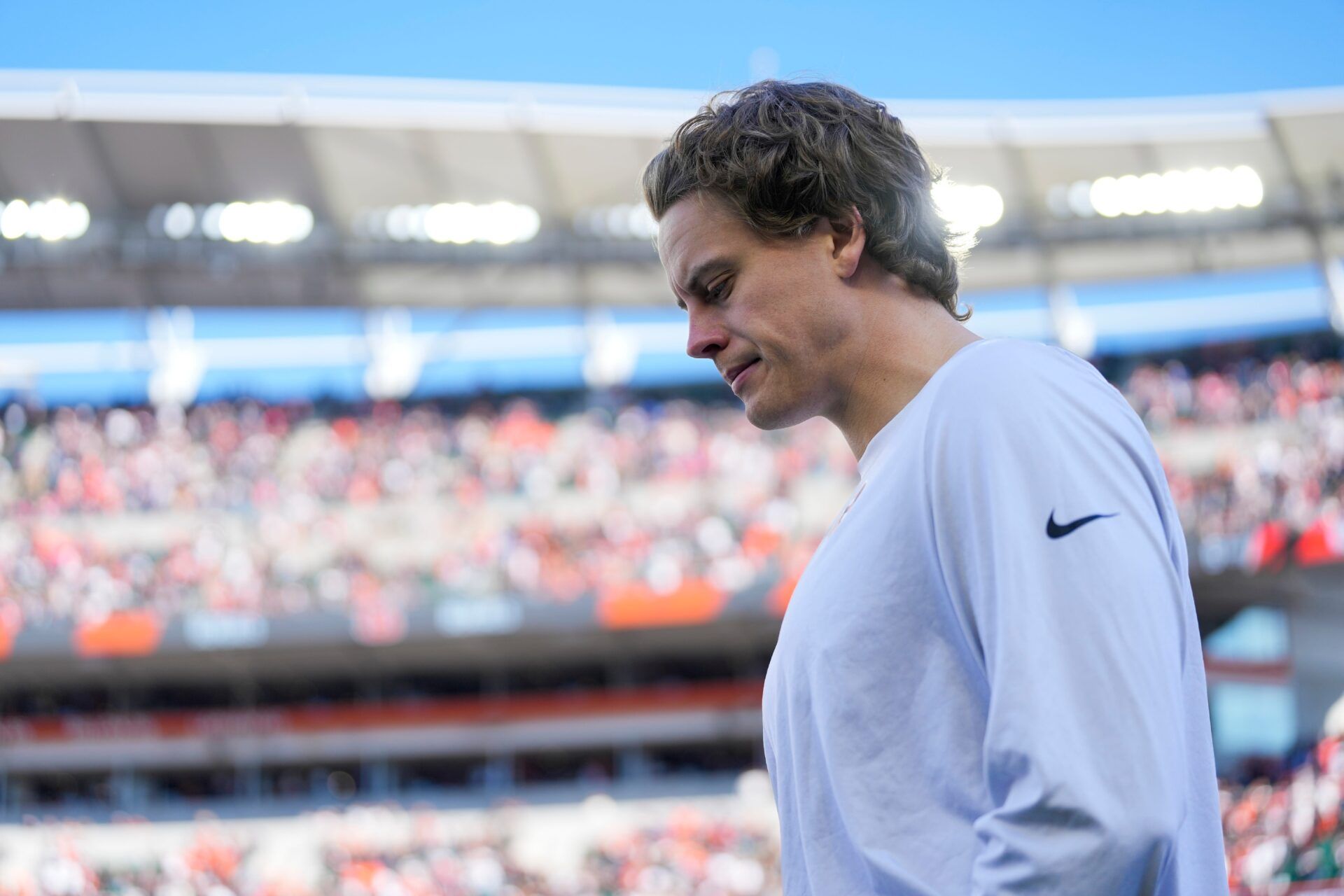 Injured Cincinnati Bengals quarterback Joe Burrow (9) walks onto the field before the first quarter of the NFL Week 12 game between the Cincinnati Bengals and the New England Patriots at Paycor Stadium in downtown Cincinnati on Sunday, Nov. 23, 2025.