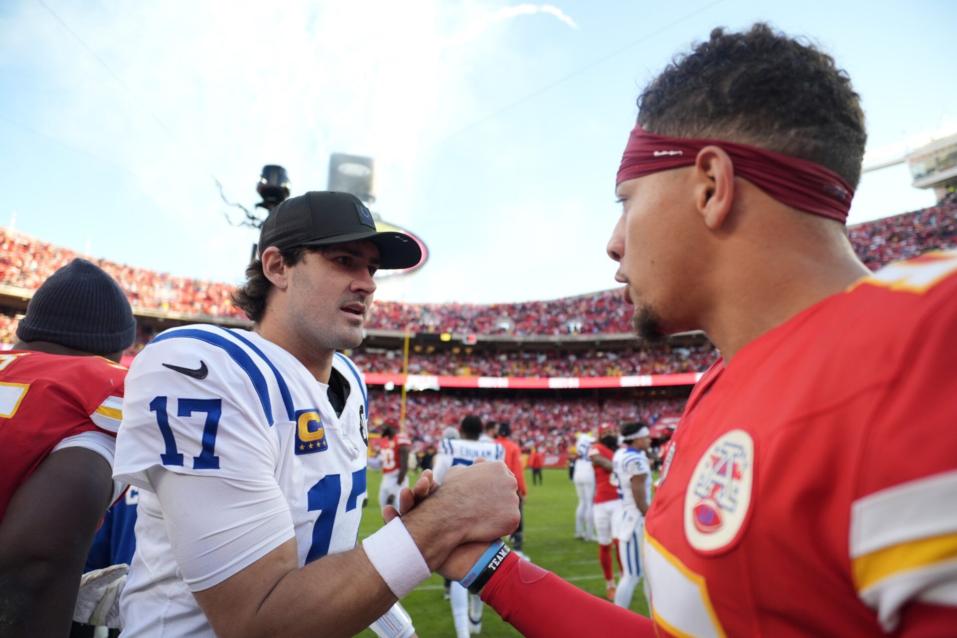 Indianapolis Colts quarterback Daniel Jones (17) and Kansas City Chiefs quarterback Patrick Mahomes (15) meet on field after the game at GEHA Field at Arrowhead Stadium.