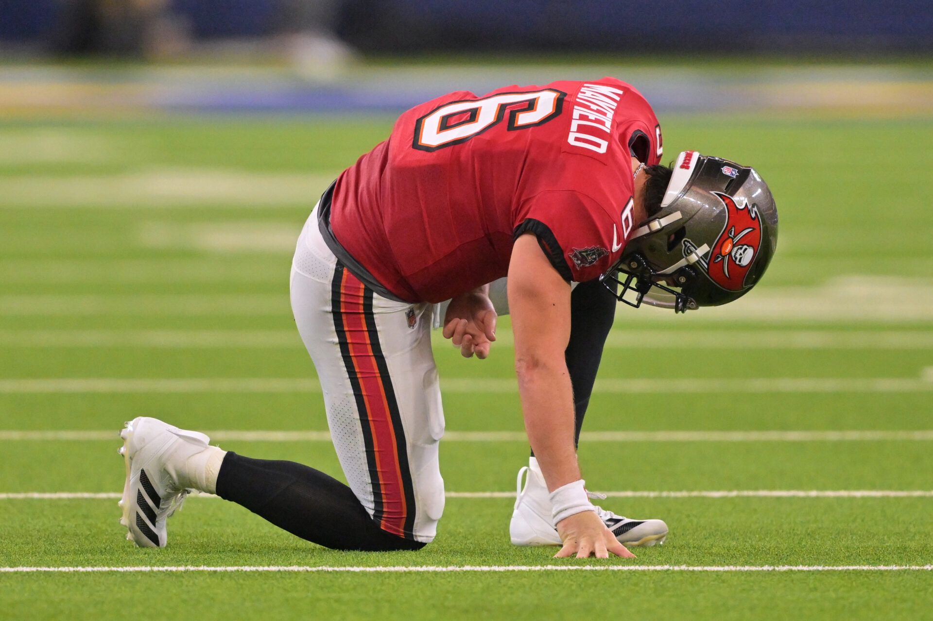 Tampa Bay Buccaneers quarterback Baker Mayfield (6) kneels on the field with an apparent injury against the Los Angeles Rams during the second quarter at SoFi Stadium.