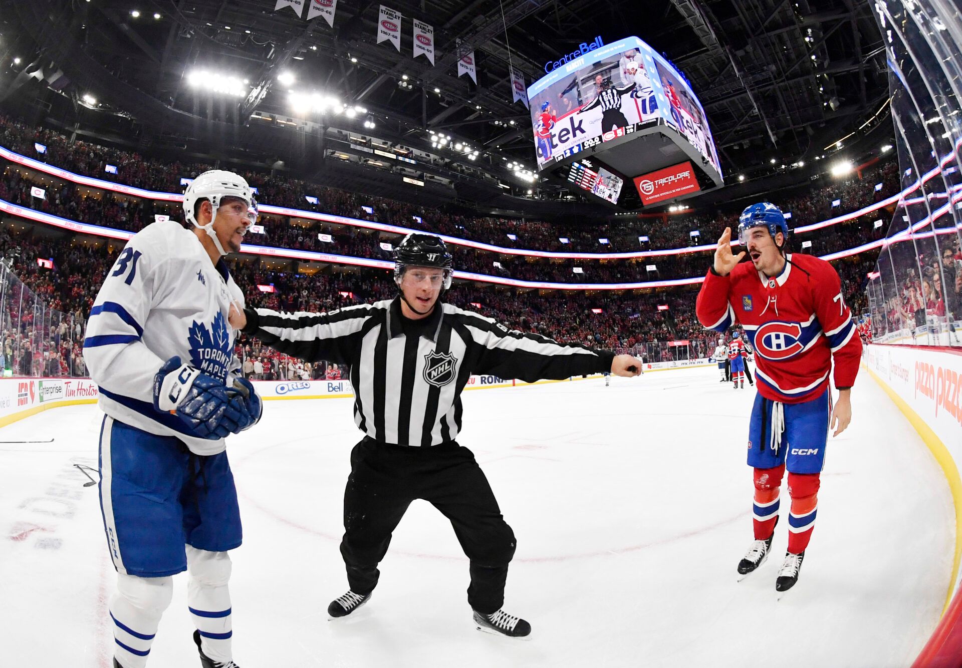 linesman Libor Suchanek (60) seperates Toronto Maple Leafs forward Dakota Joshua (81) and Montreal Canadiens defenseman Arber Xhekaj (72) after the game at the Bell Centre.