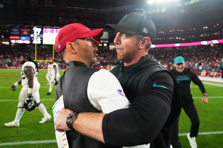 Jacksonville Jaguars head coach Liam Coen greets Arizona Cardinals head coach Jonathan Gannon on the field after the game at State Farm Stadium.