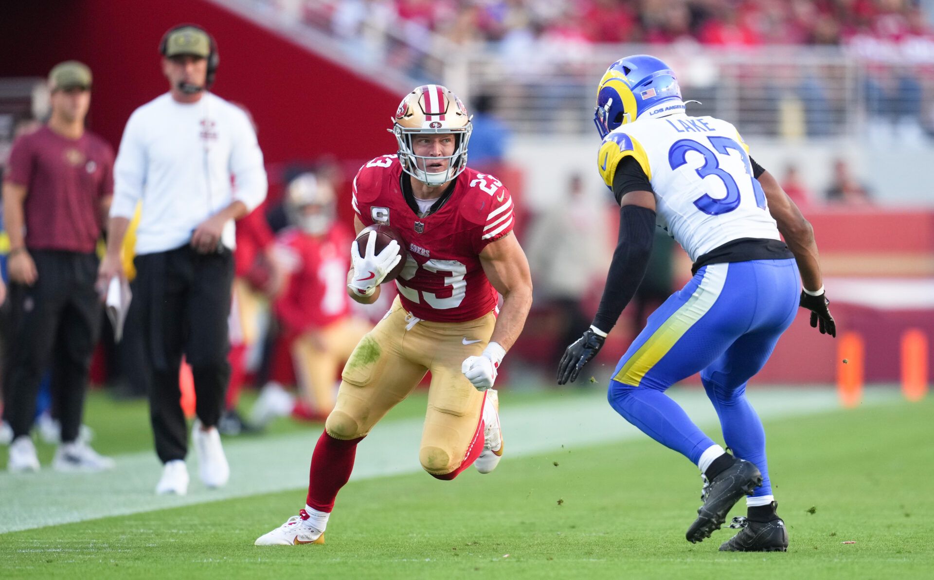 San Francisco 49ers running back Christian McCaffrey (23) runs the ball against Los Angeles Rams safety Quentin Lake (37) during the second quarter at Levi's Stadium.