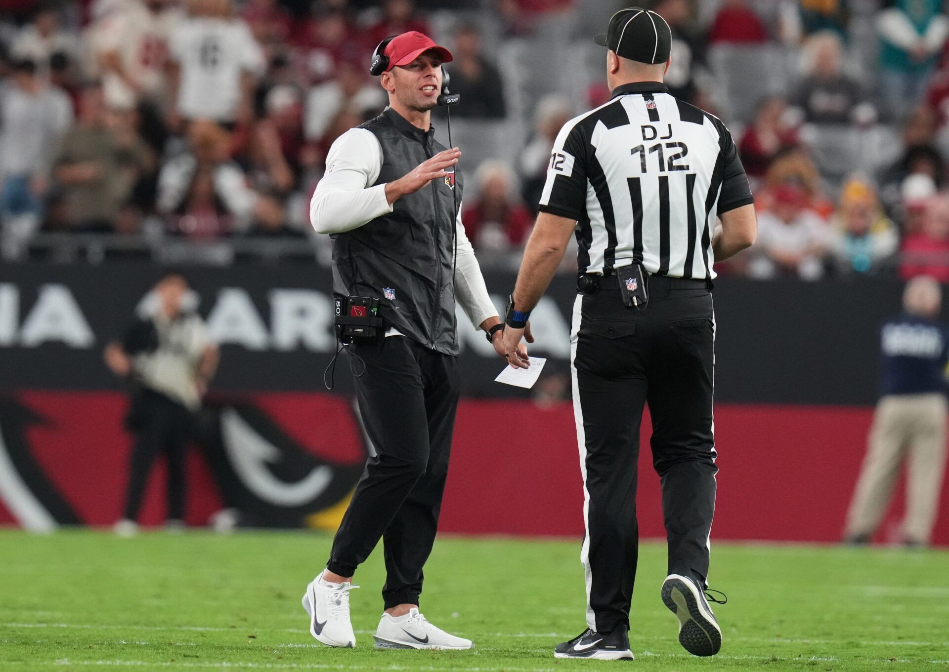Arizona Cardinals head coach Jonathan Gannon talks to a referee during their game against the Jacksonville Jaguars at State Farm Stadium on Nov. 23, 2025.