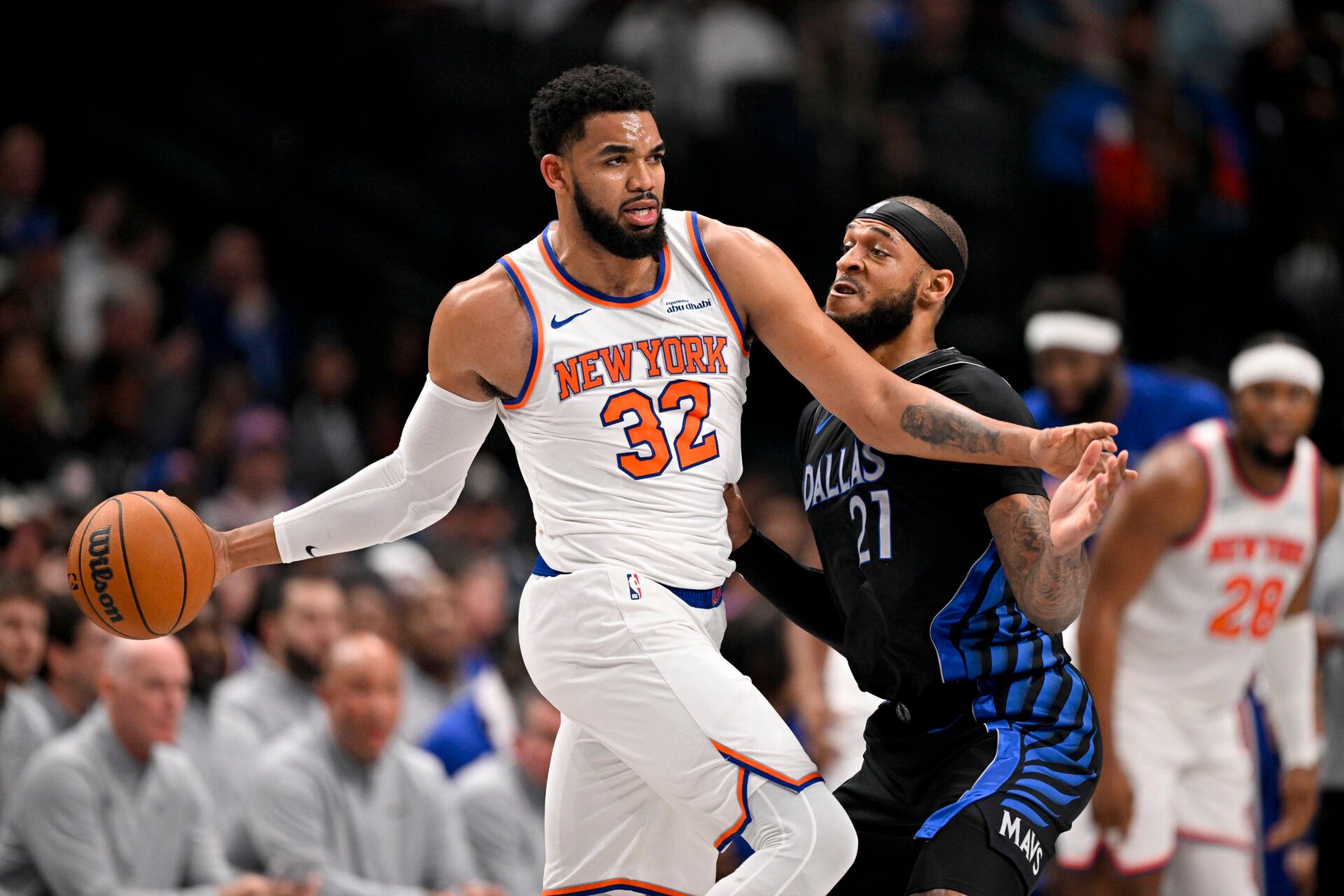 New York Knicks center Karl-Anthony Towns (32) looks to move the ball past Dallas Mavericks forward Daniel Gafford (21) during the first quarter at the American Airlines Center.