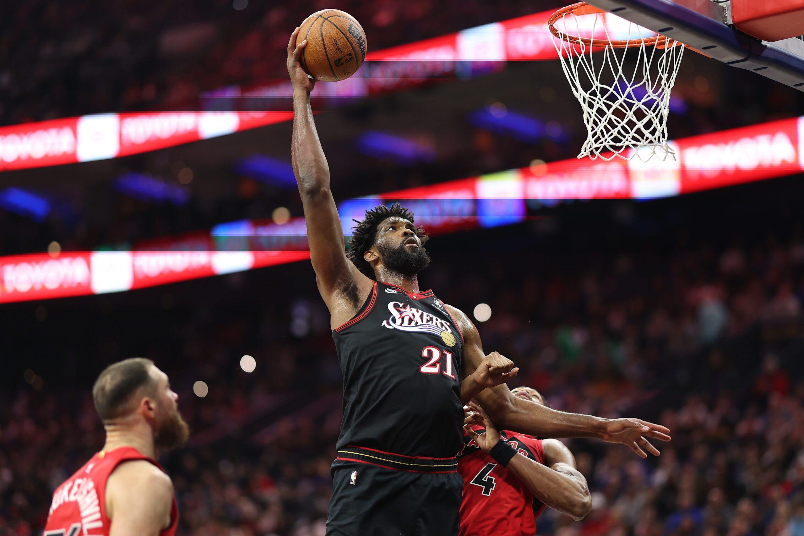 Philadelphia 76ers center Joel Embiid (21) drives for a shot against Toronto Raptors forward Scottie Barnes (4) during the second quarter at Xfinity Mobile Arena.