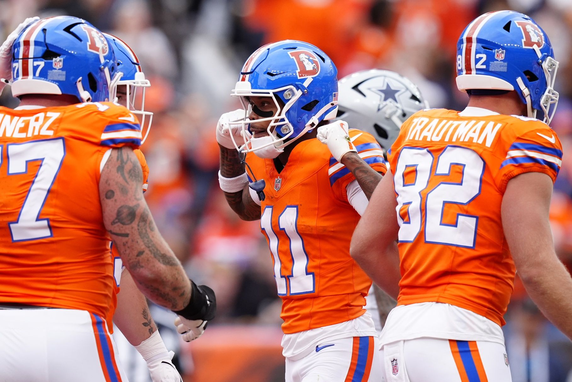 Denver Broncos wide receiver Troy Franklin (11) celebrates after scoring a touchdown against the Dallas Cowboys in the second quarter at Empower Field at Mile High.