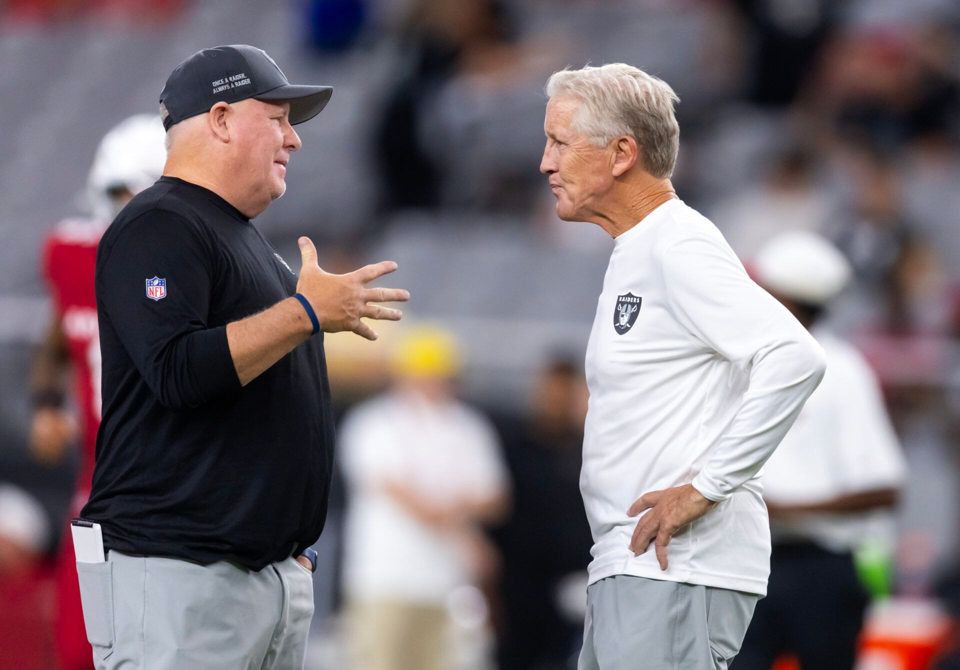 Las Vegas Raiders offensive coordinator Chip Kelly (left) with head coach Pete Carroll against the Arizona Cardinals during a preseason NFL game at State Farm Stadium.