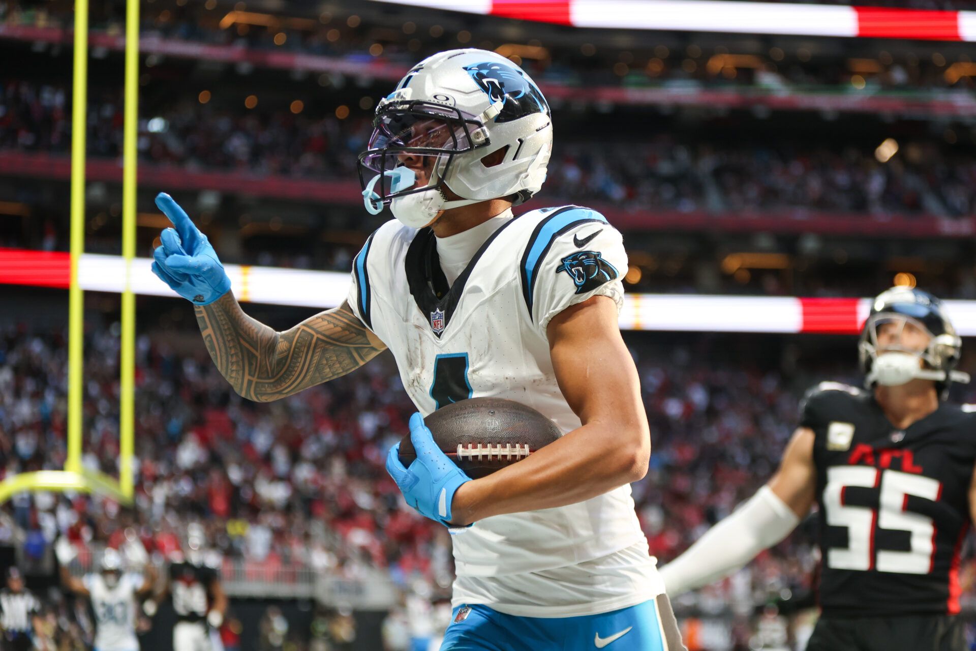 Carolina Panthers wide receiver Tetairoa McMillan (4) celebrates a touchdown in the fourth quarter against the Atlanta Falcons at Mercedes-Benz Stadium.