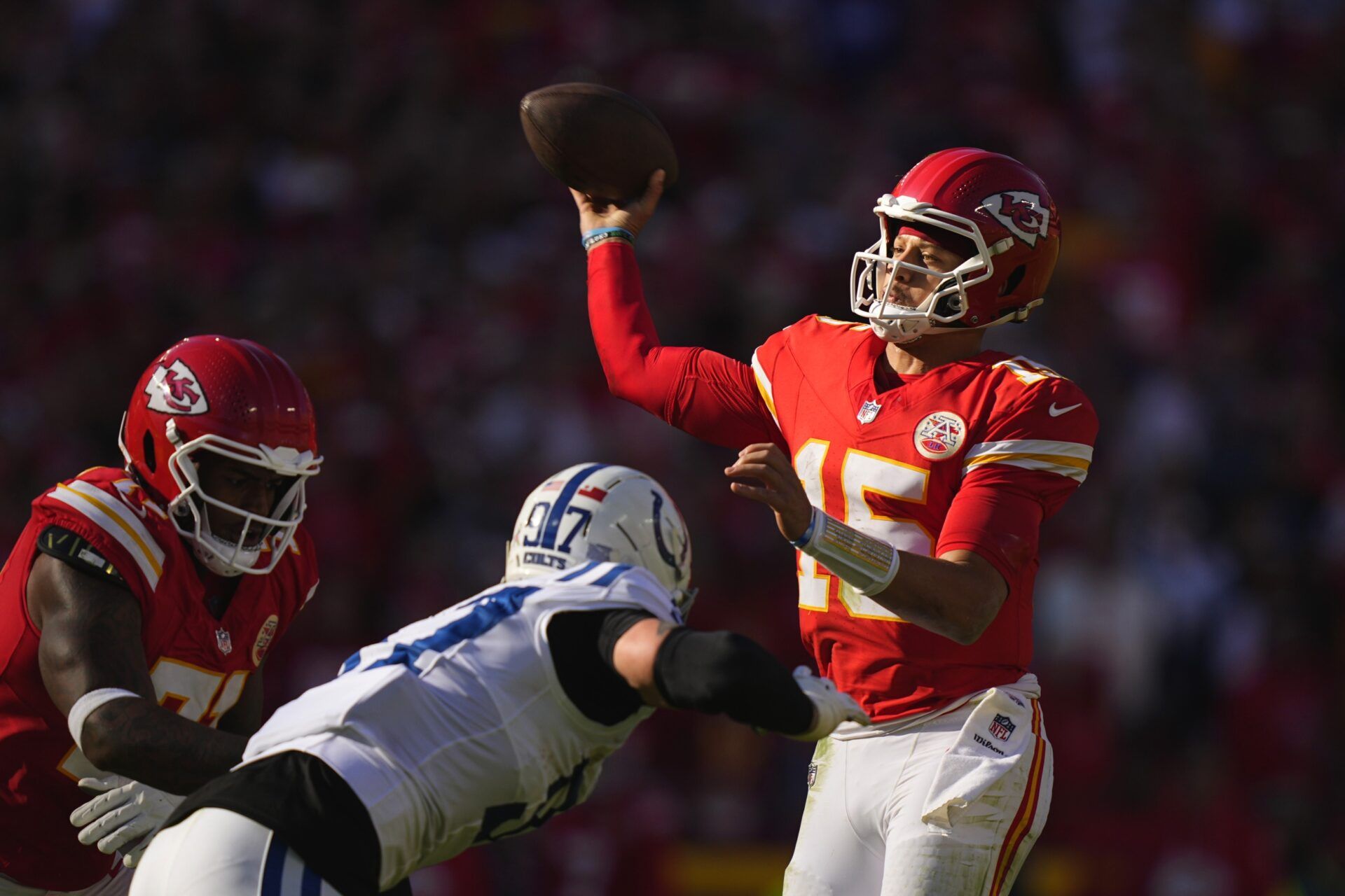 Kansas City Chiefs quarterback Patrick Mahomes (15) throws a pass against Indianapolis Colts defensive end Laiatu Latu (97) in the first half at GEHA Field at Arrowhead Stadium.