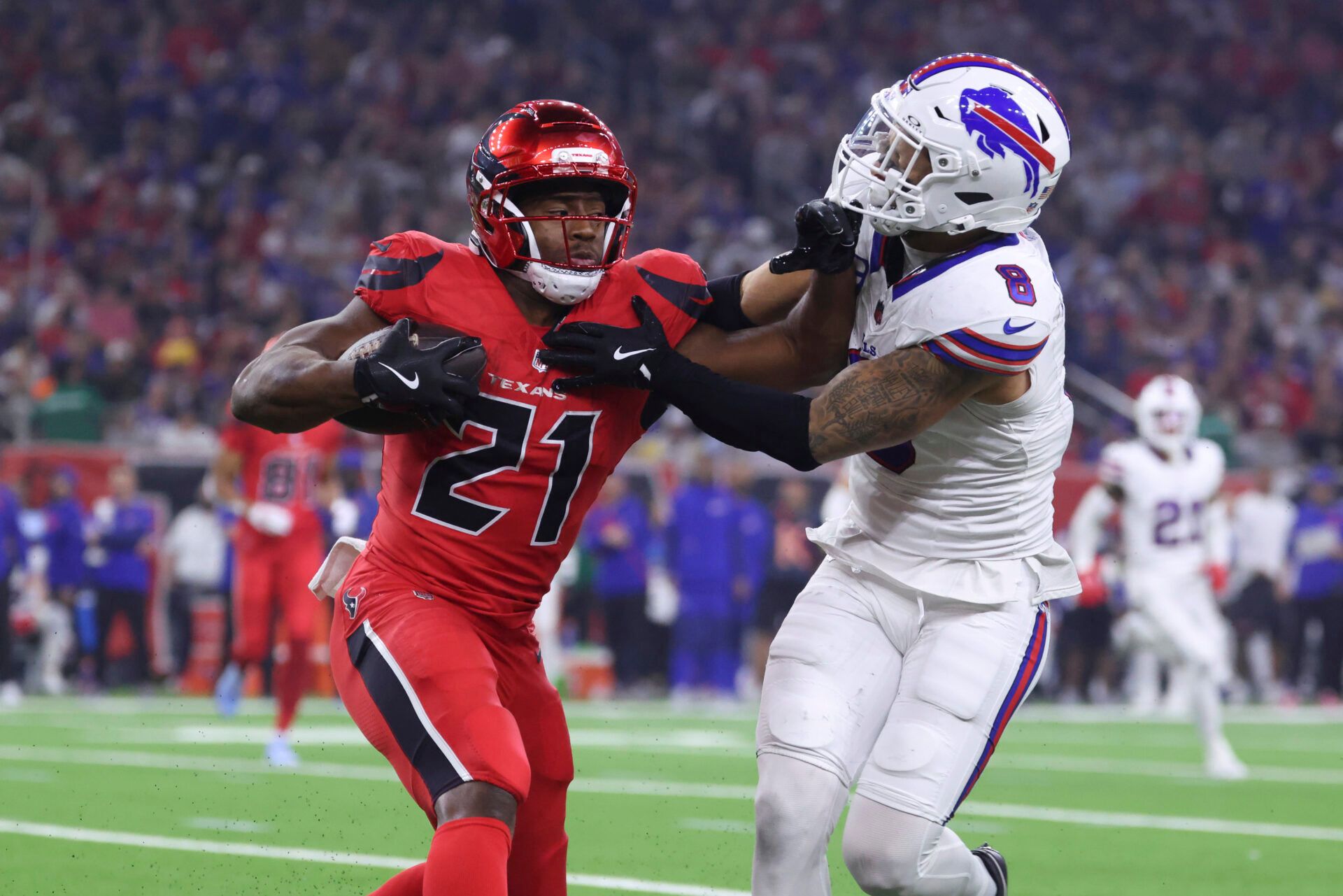 Houston Texans running back Nick Chubb (21) runs with the ball as Buffalo Bills linebacker Terrel Bernard (8) attempts to make a tackle during the game at NRG Stadium.
