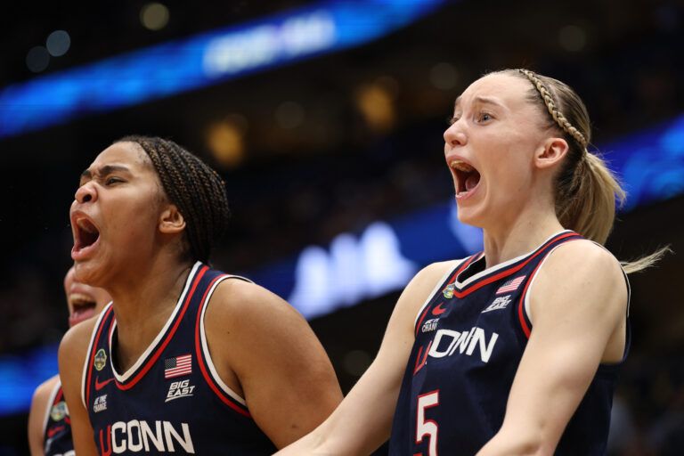 Connecticut Huskies guard Paige Bueckers (5) and forward Sarah Strong (21) react on the bench during the fourth quarter in a semifinal of the women's 2025 NCAA tournament against the UCLA Bruins at Amalie Arena.