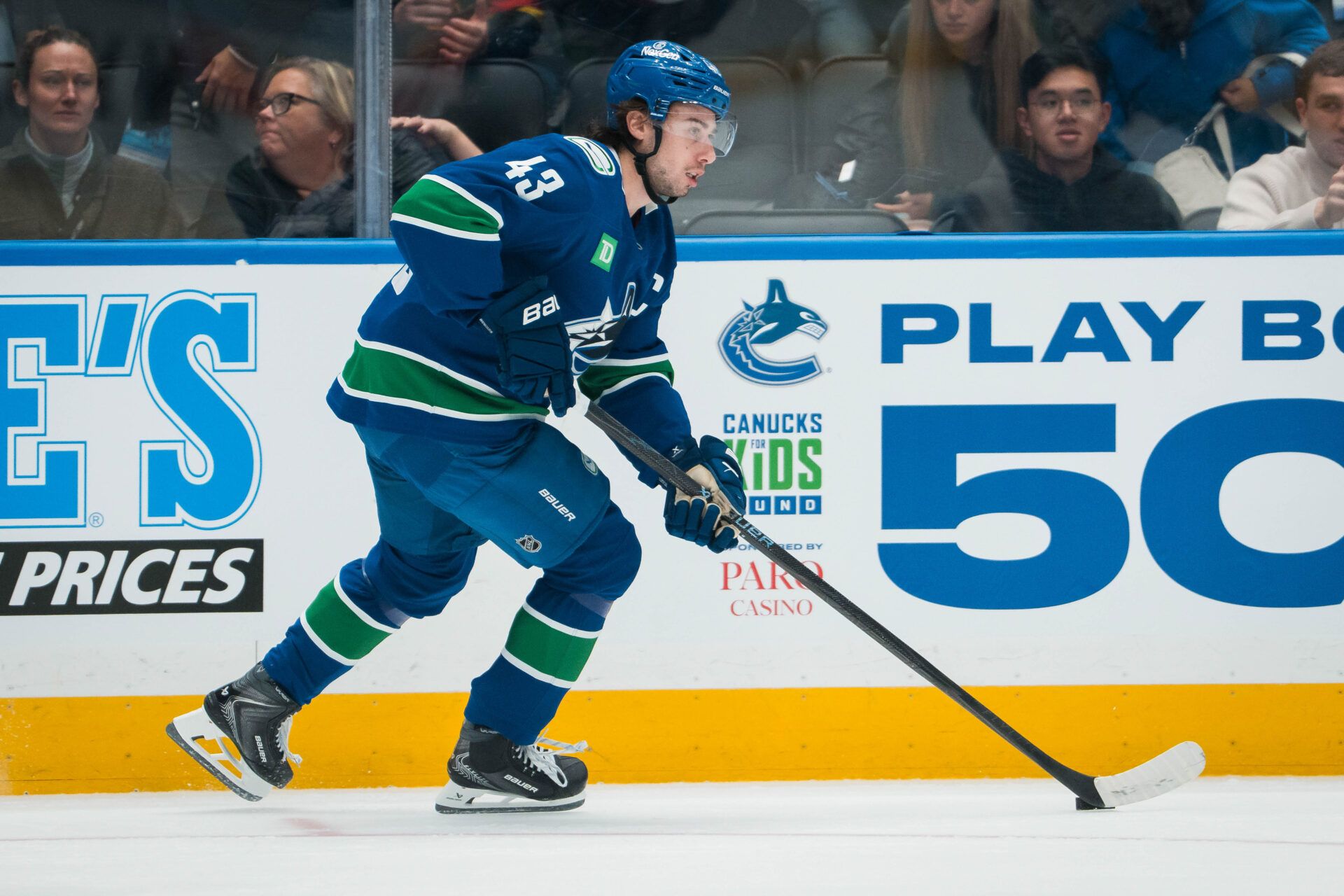 Vancouver Canucks defenseman Quinn Hughes (43) handles the puck against the Winnipeg Jets in the first period at Rogers Arena.