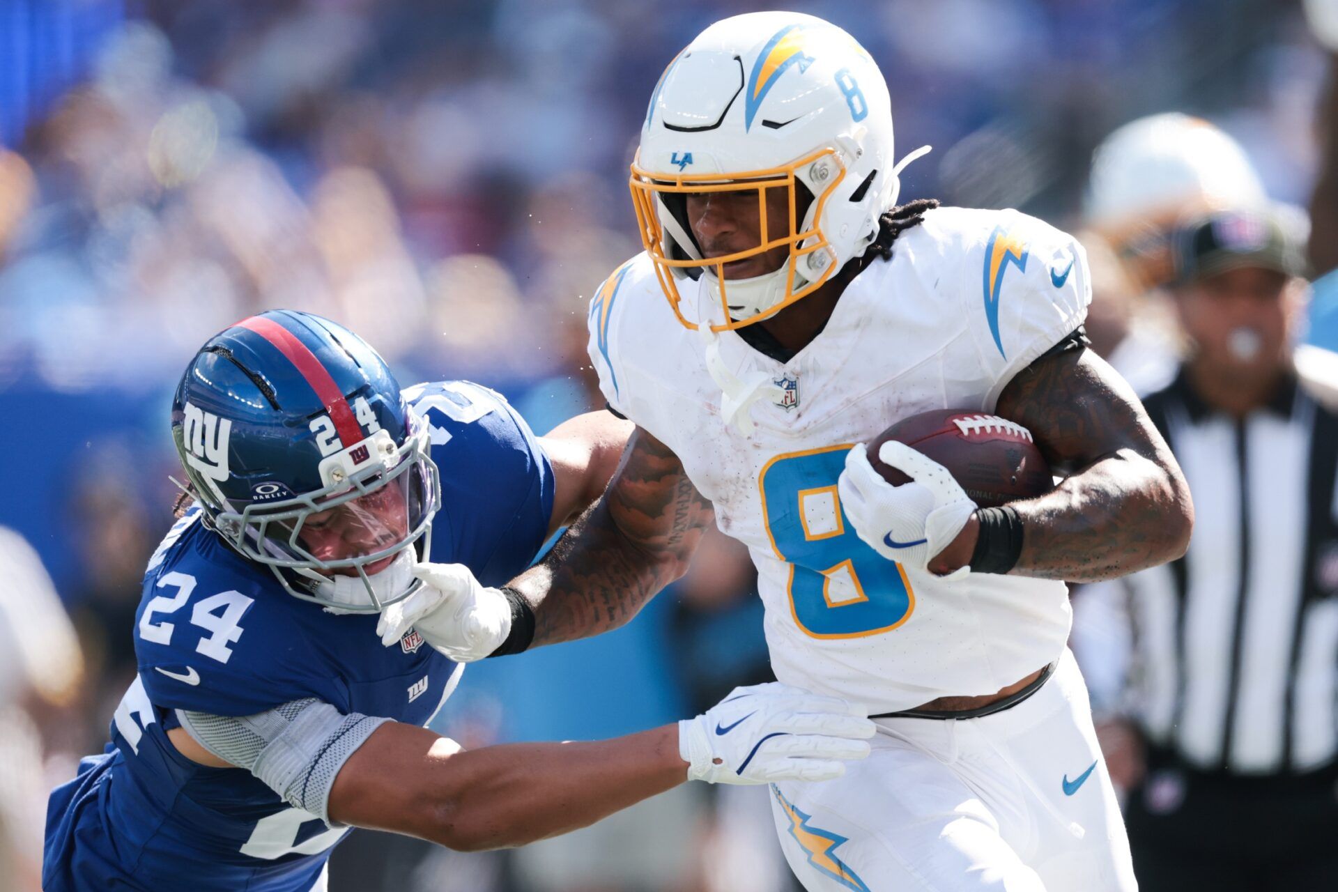 Los Angeles Chargers running back Omarion Hampton (8) rushes as New York Giants safety Dane Belton (24) defends during the second quarter at MetLife Stadium.