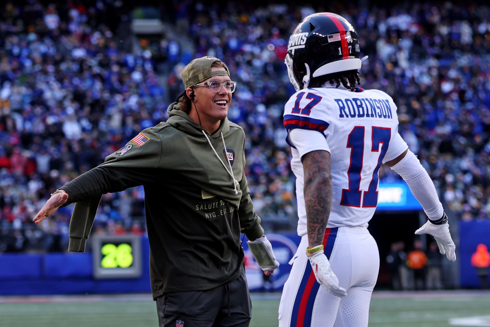 New York Giants injured quarterback Jaxson Dart celebrates with wide receiver Wan'Dale Robinson (17) on the sideline during the second quarter of the game against the Green Bay Packers at MetLife Stadium.