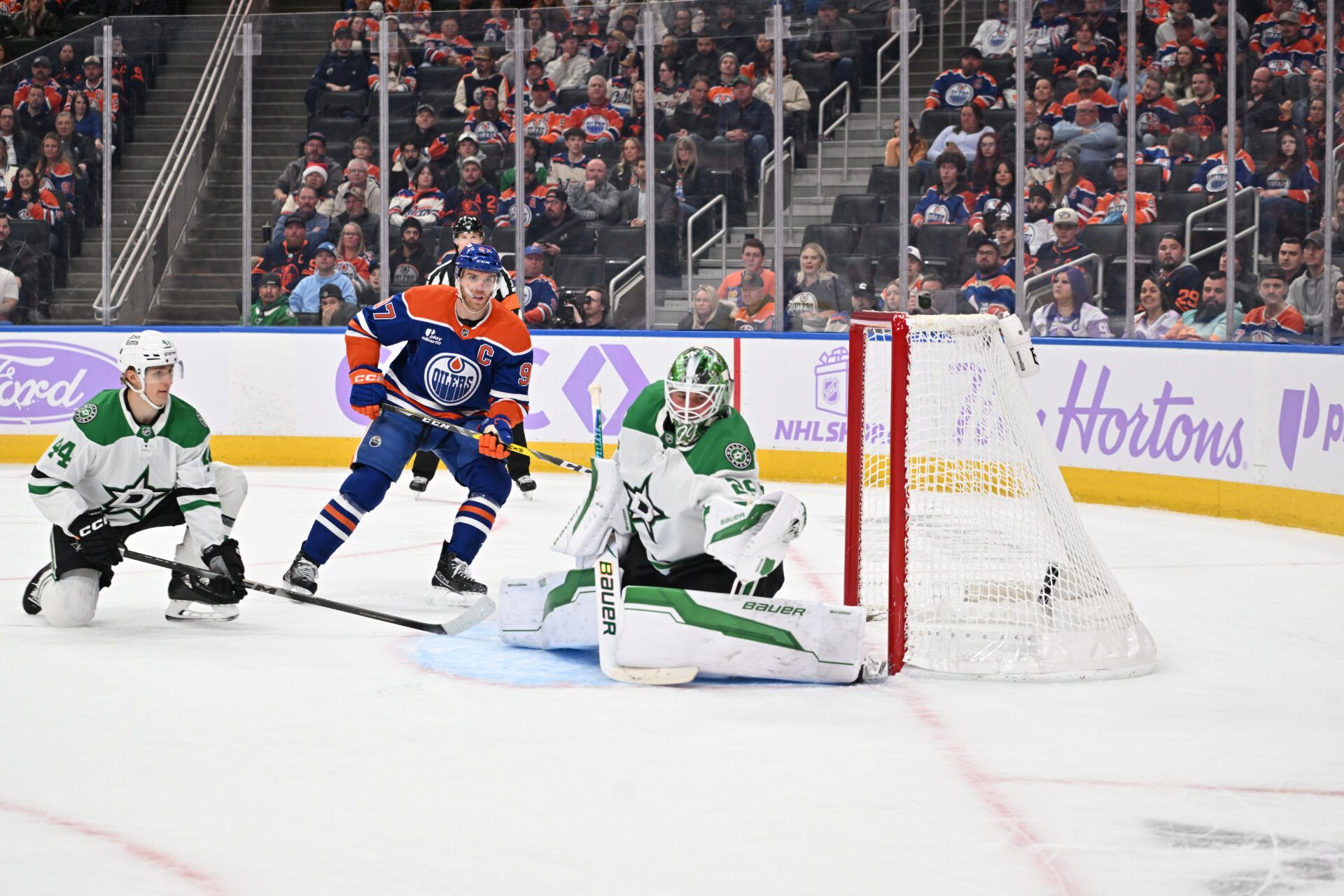 Dallas Stars defenceman Vladislav Kolychonok (44) along with Edmonton Oilers centre Connor McDavid (97) look on as Stars goalie (29) Jake Oettinger makes a glove save during the third period at Rogers Place.