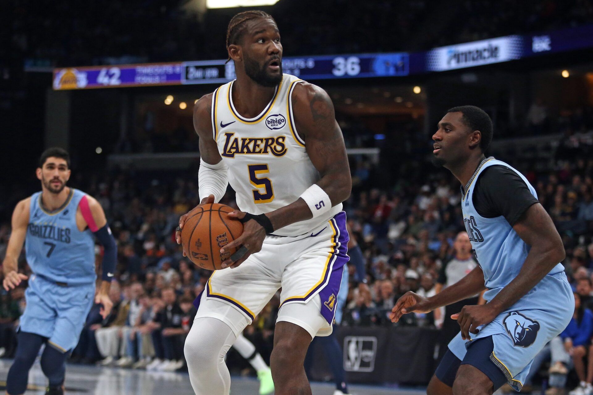 Los Angeles Lakers center Deandre Ayton (5) spins to the basket as Memphis Grizzlies forward Vince Williams Jr. (5) defends during the second quarter at FedExForum.