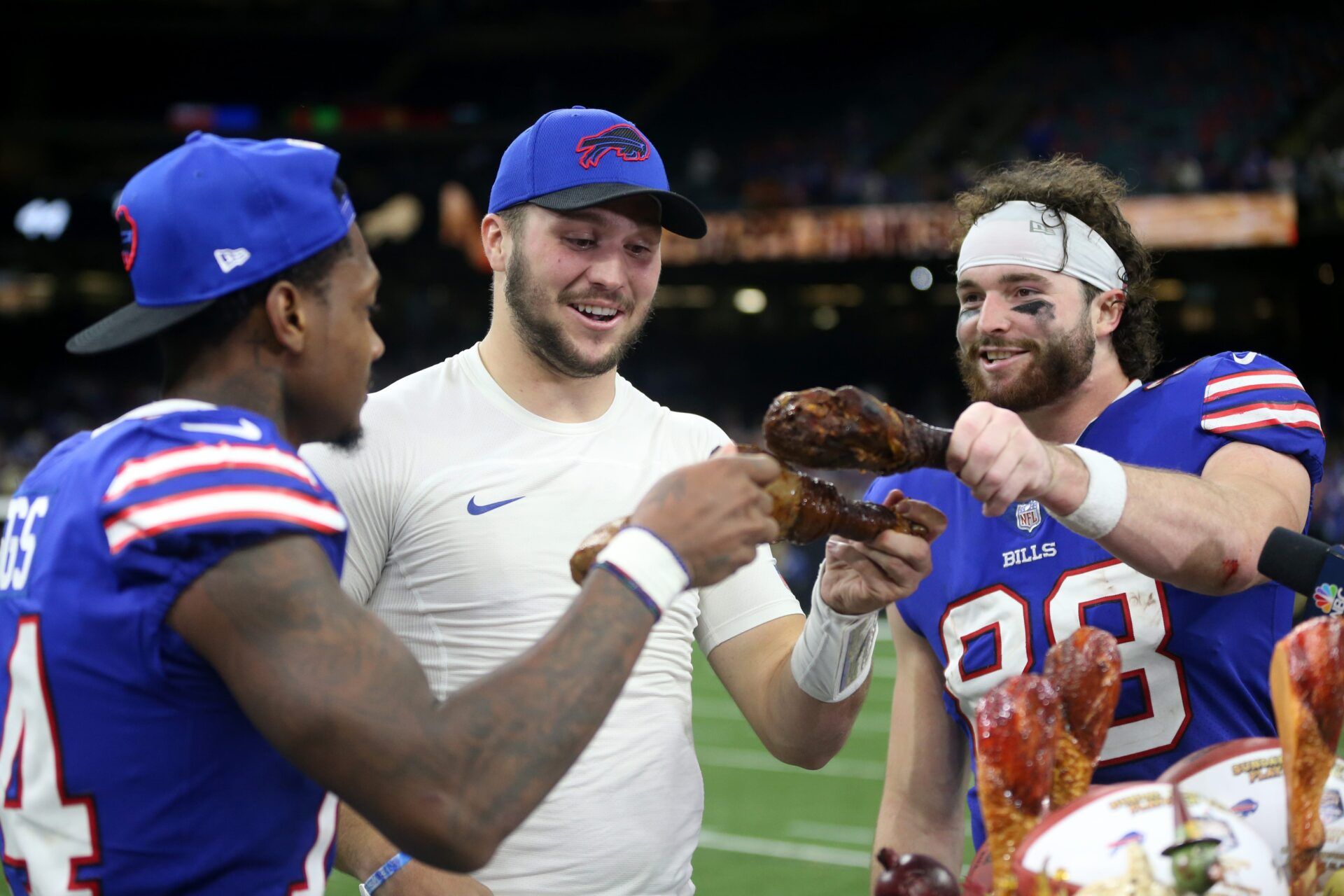 Buffalo Bills wide receiver Stefon Diggs (14) and quarterback Josh Allen (17) and tight end Dawson Knox (88) enjoy a turkey leg at the end of their game against the New Orleans Saints at the Caesars Superdome.